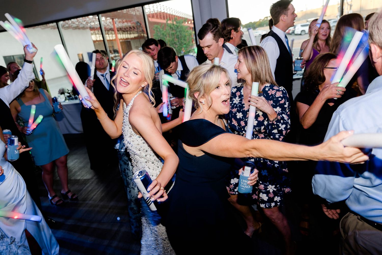Large group of wedding guests dancing and having fun at the reception.