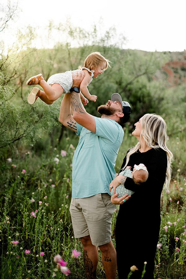 Candid family photos showing playful interactions in a flowering meadow at sunset.