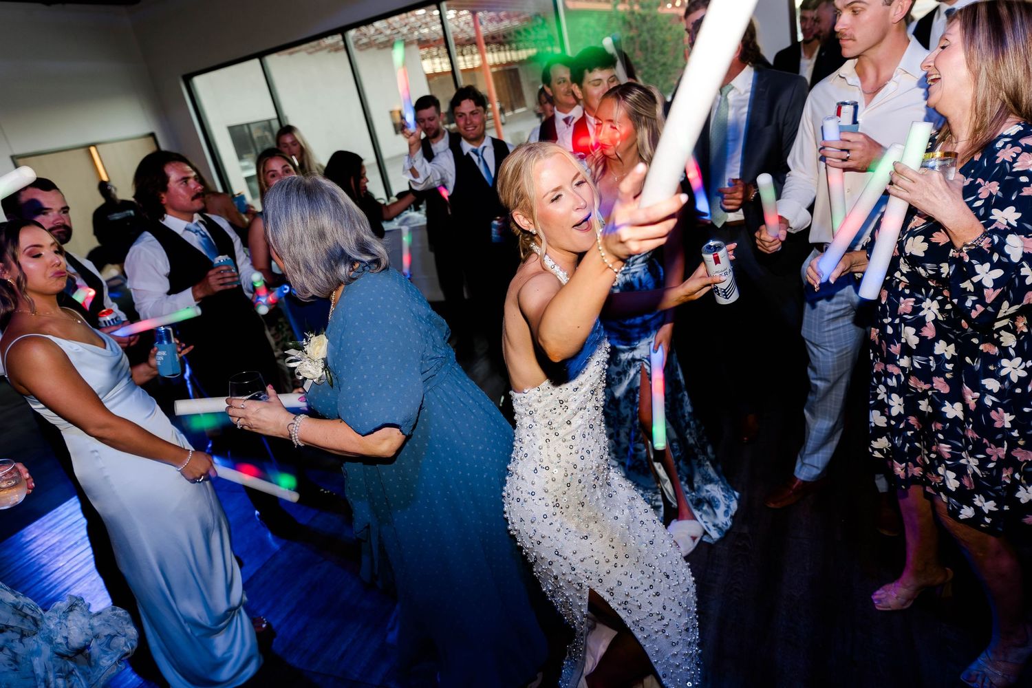 Guests enjoying themselves on a lively wedding reception dance floor.