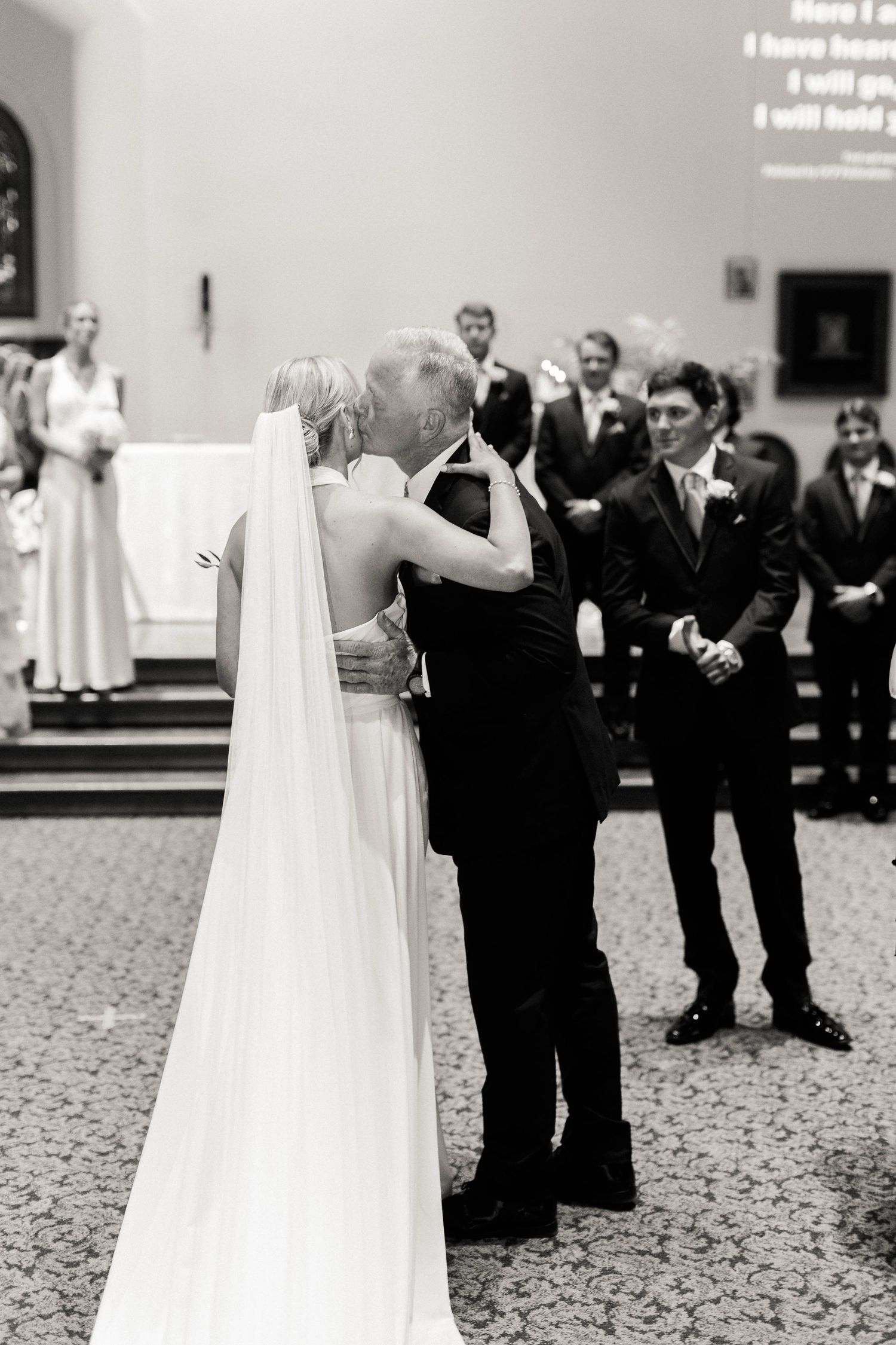 A tender moment during a wedding ceremony in a church setting.