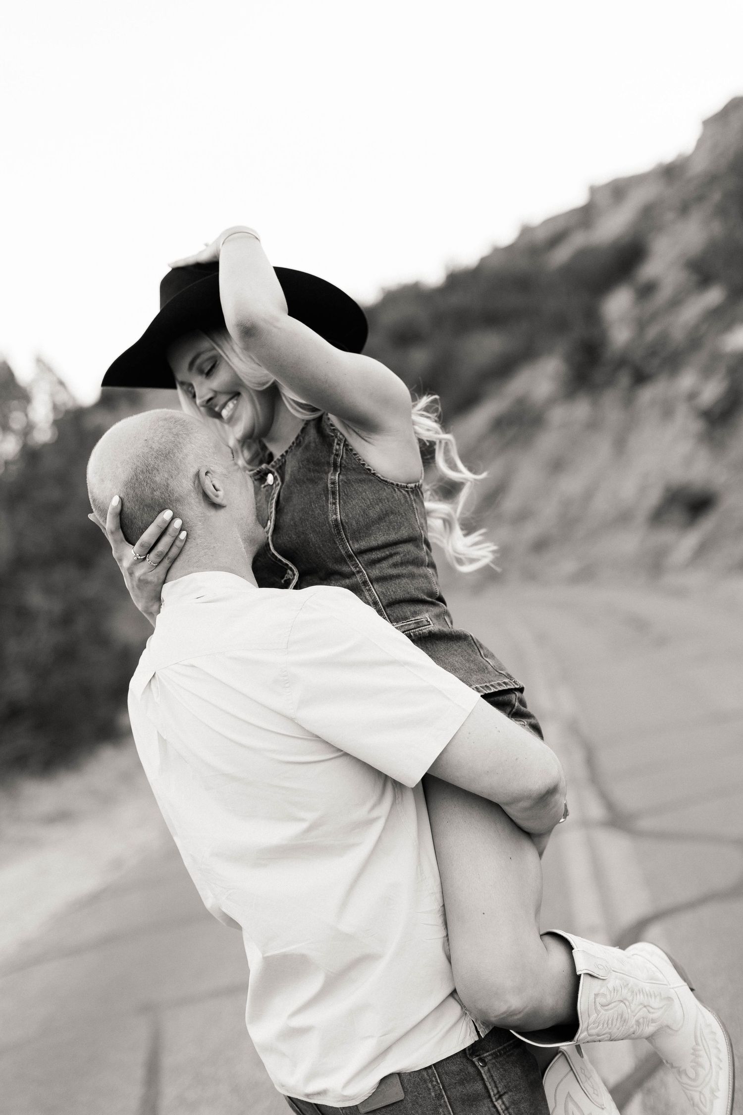 Black and white romantic portrait of couple in casual wear during outdoor photoshoot.