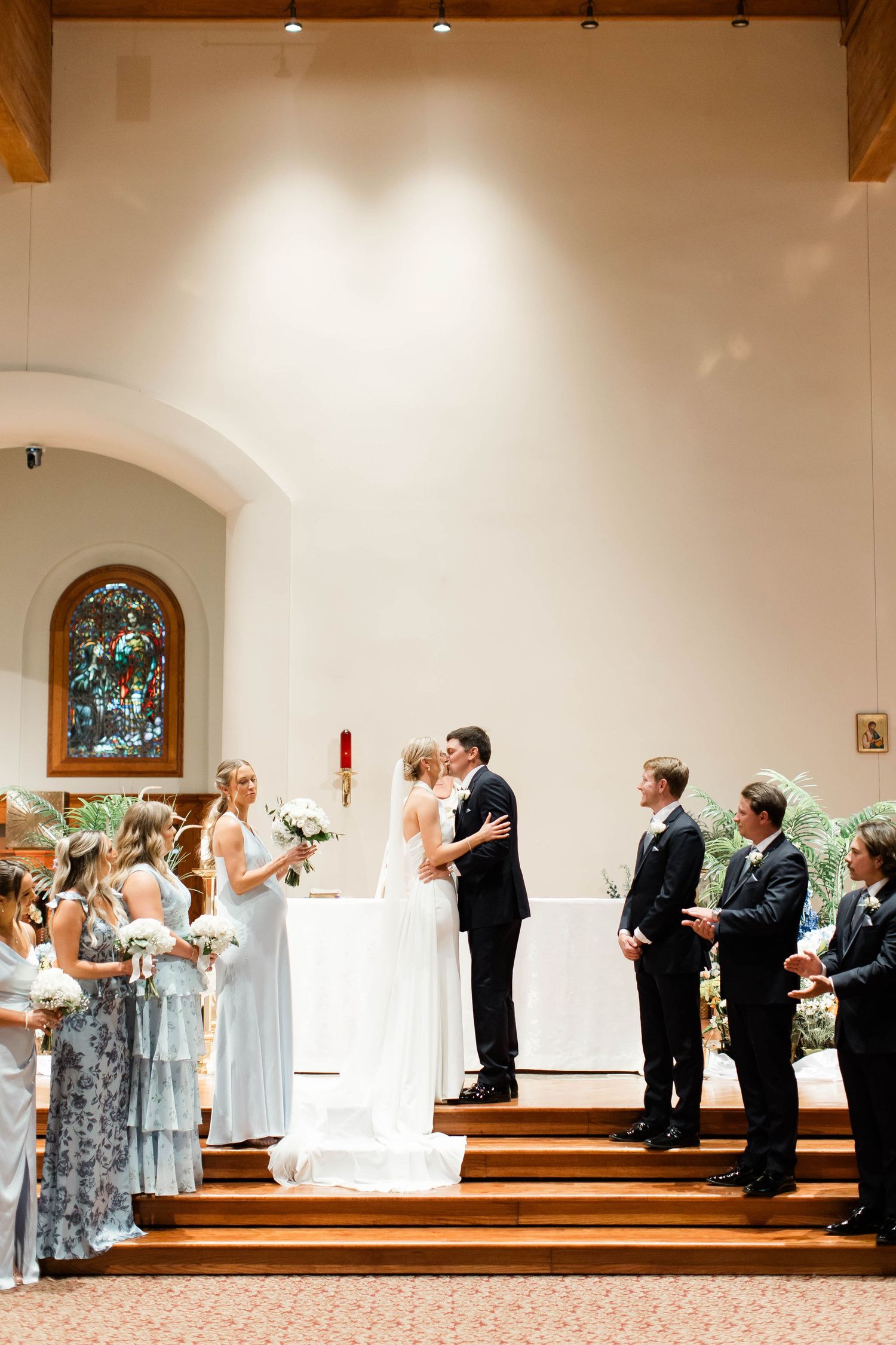 Wedding party performing synchronized movements during church ceremony.