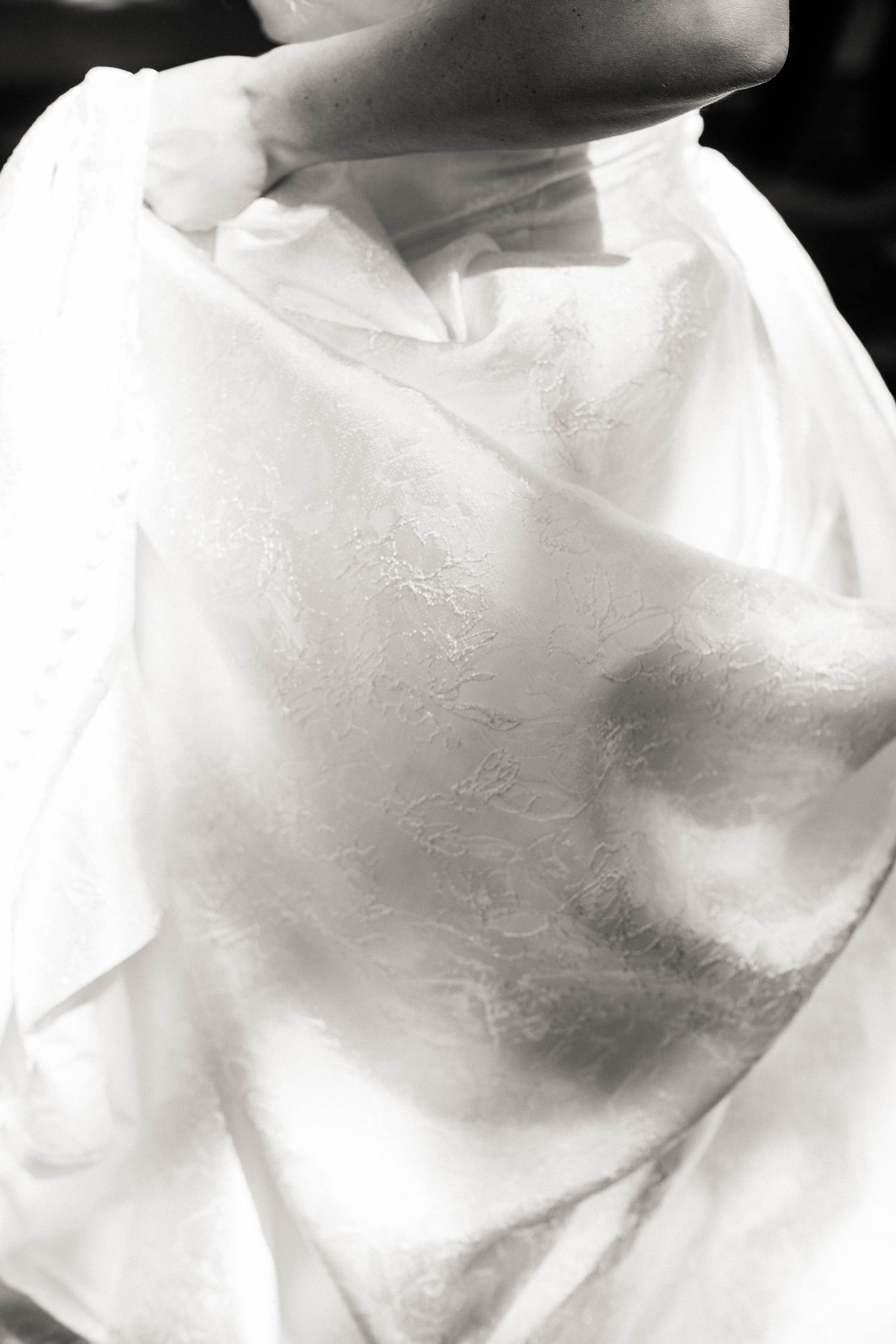 Abstract close-up details of white wedding dress fabric texture.