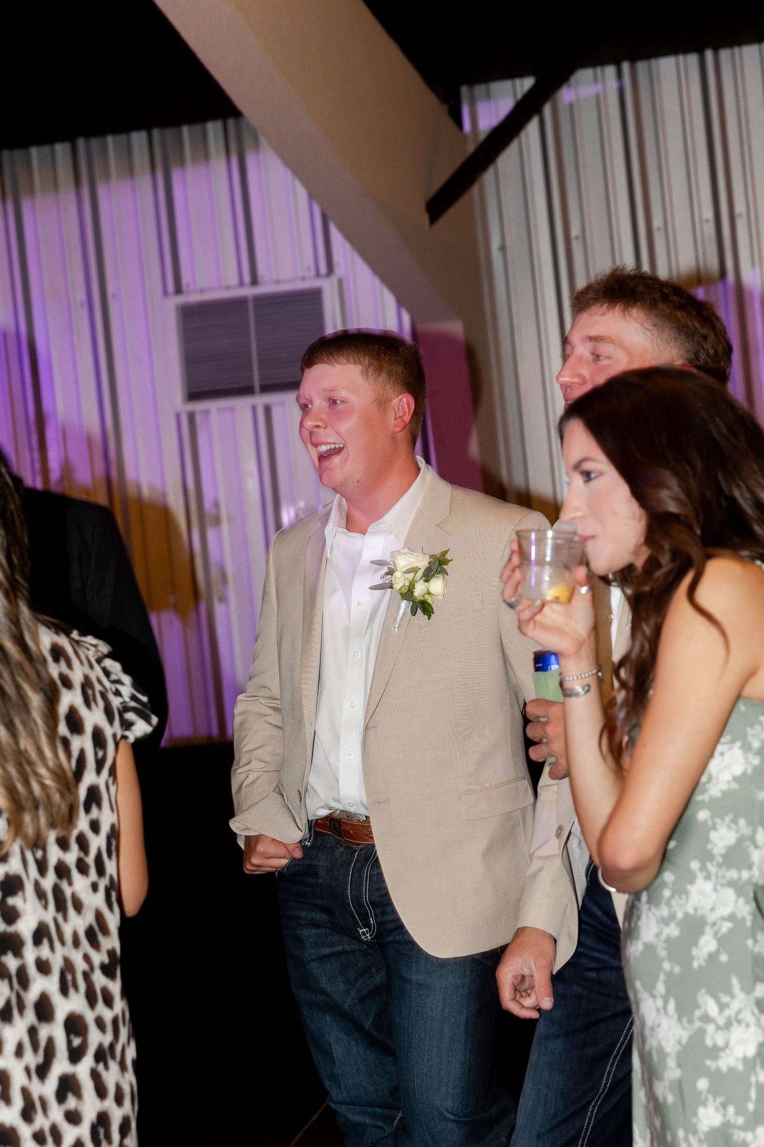 A couple shares laughter and dancing during their wedding reception.