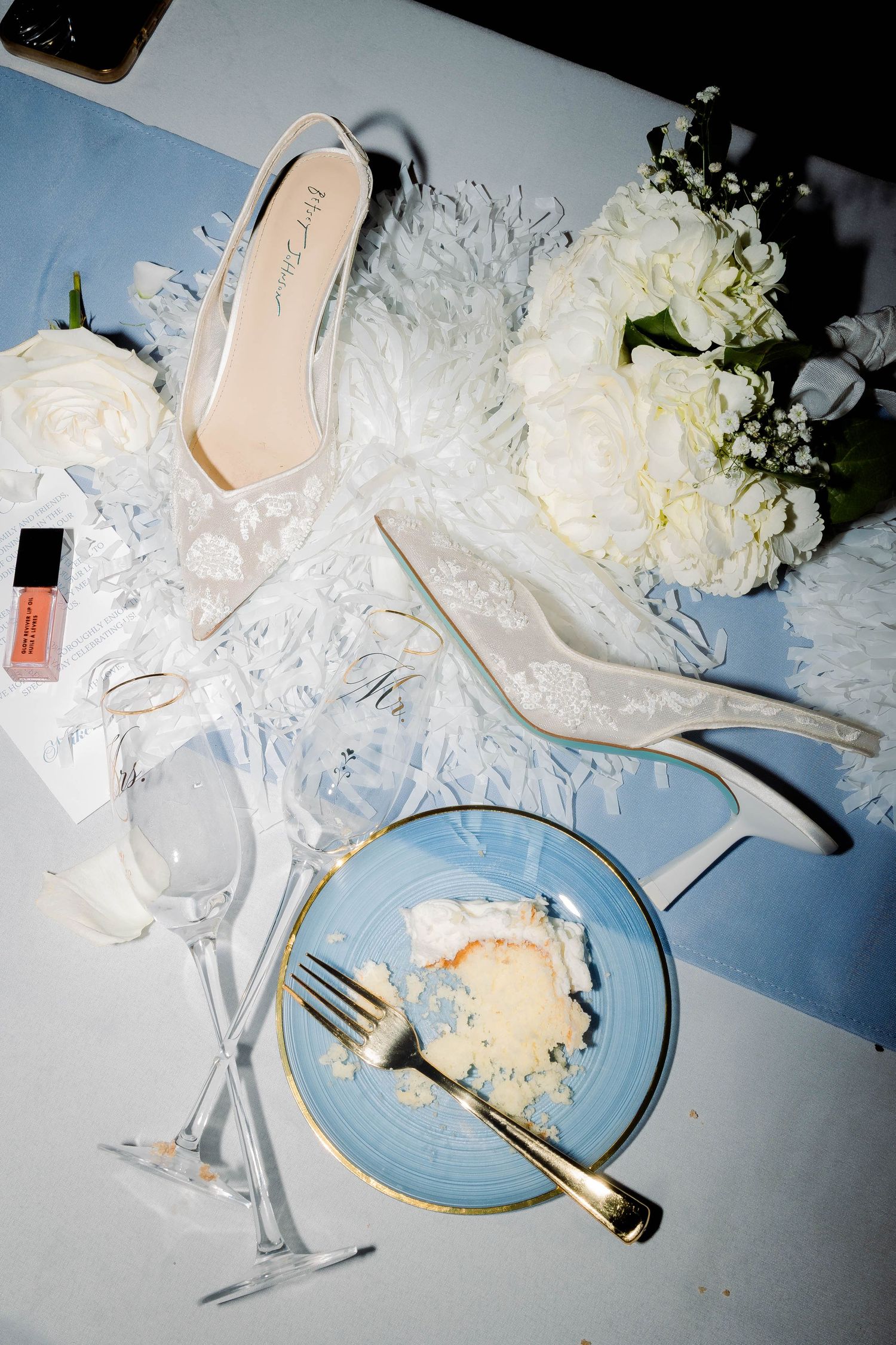 Wedding cake tasting plates with white floral decorations and elegant table settings.