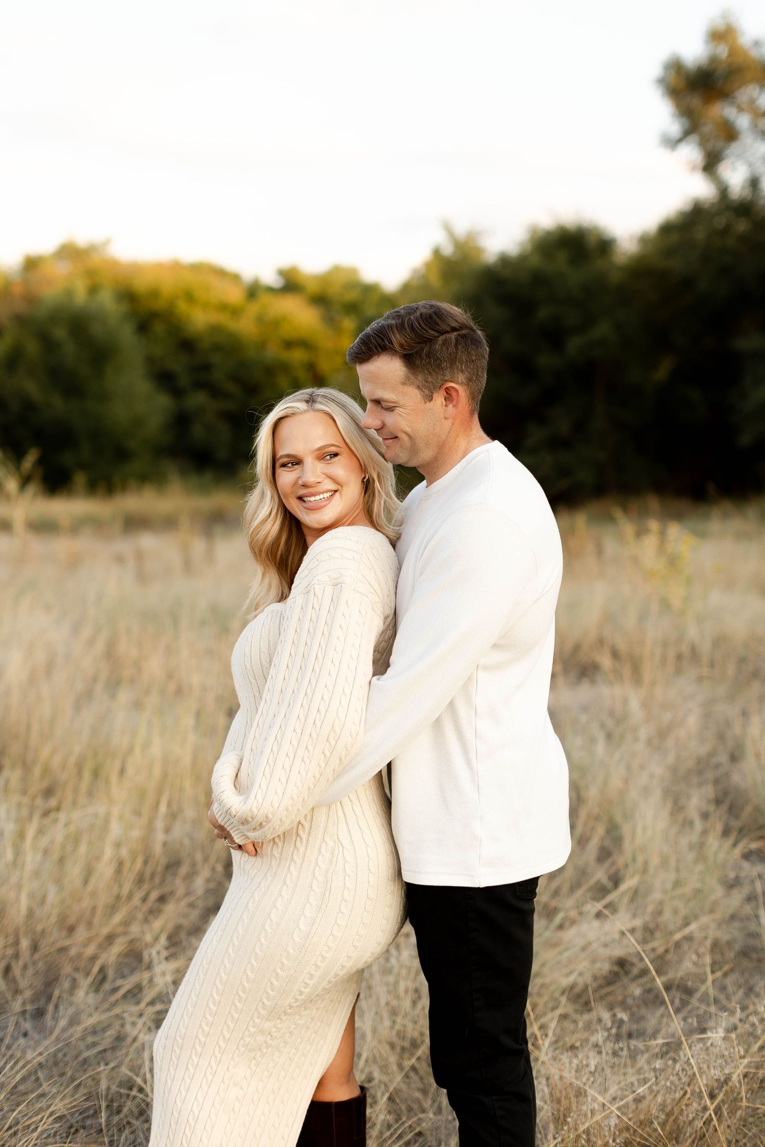 Sweet couple's maternity session in a sun-drenched field at sunset. Amarillo maternity session
