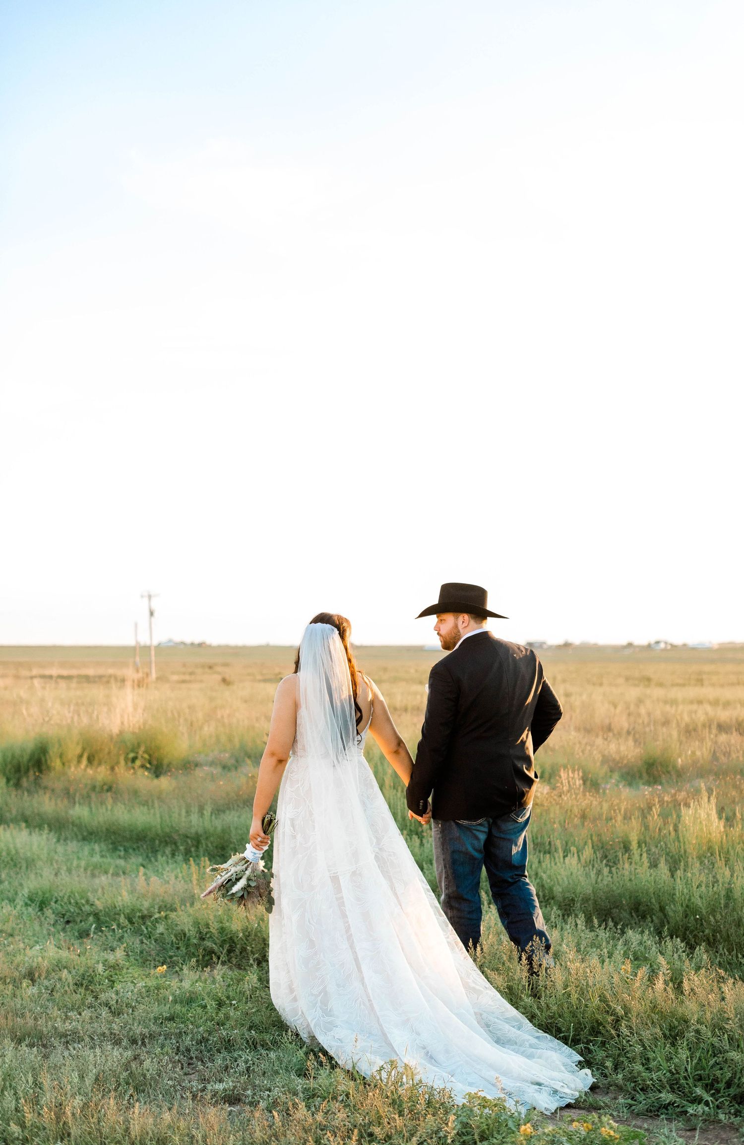 A romantic countryside photoshoot with flowing white dress in golden evening light.