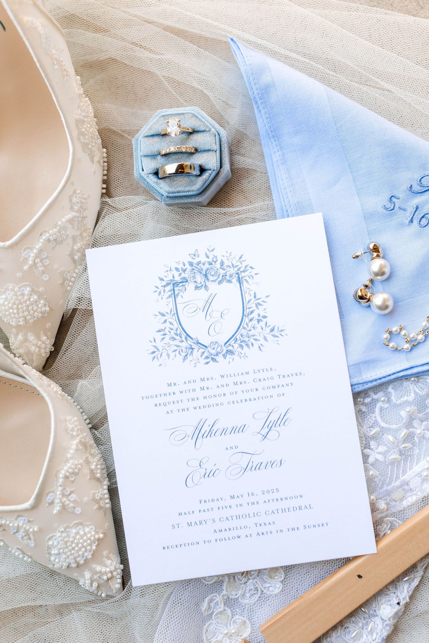Light blue and white wedding invitations with elegant typography and decorative elements.