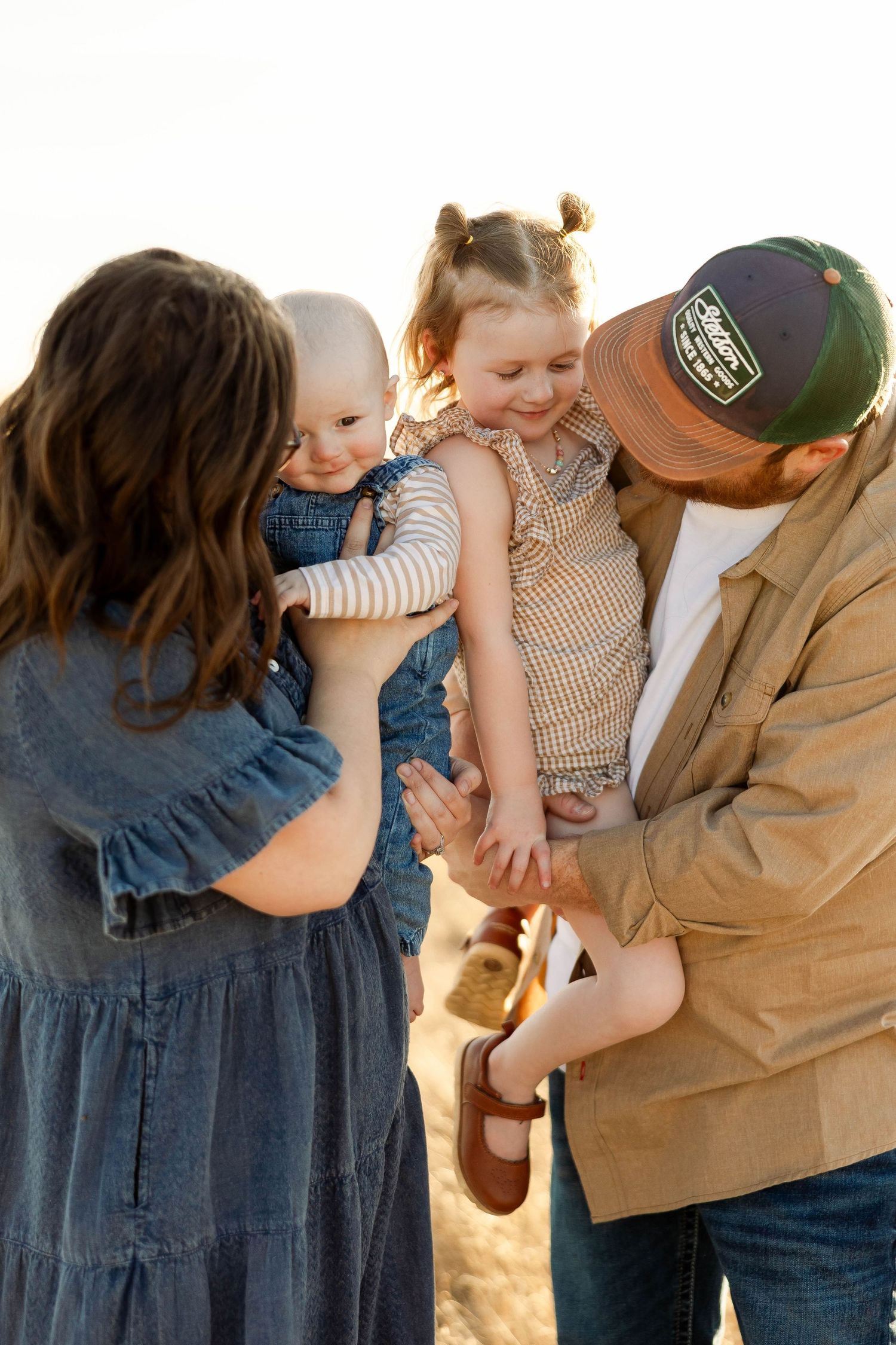 A series of candid outdoor family photos showing tender moments and embraces at golden hour.