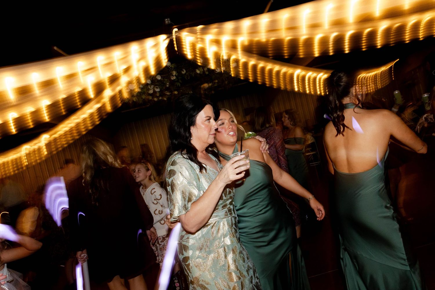 Wedding reception dance floor with string lights creating warm ambiance overhead.