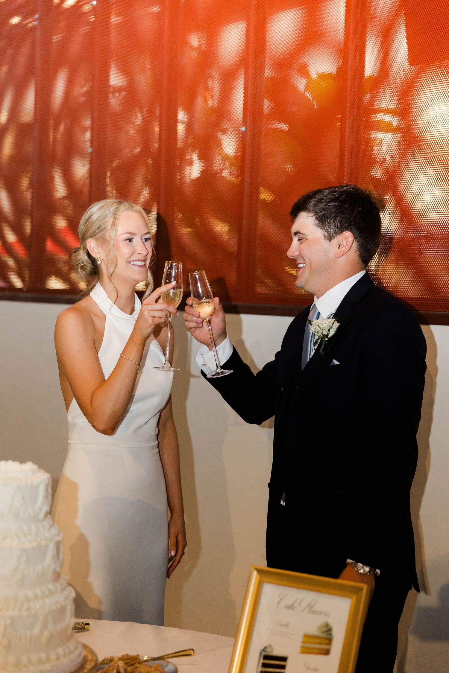 Wedding couple playfully feeding each other cake at their reception.