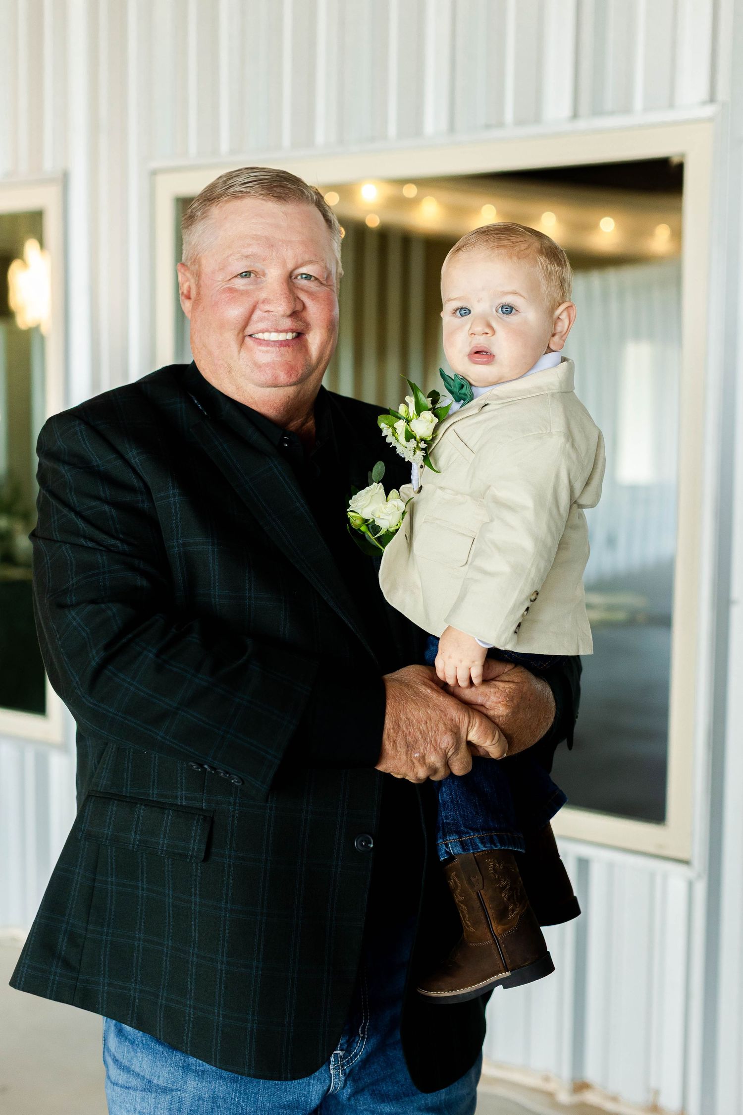 A series of candid moments captured with a baby in formal attire at an indoor event space.