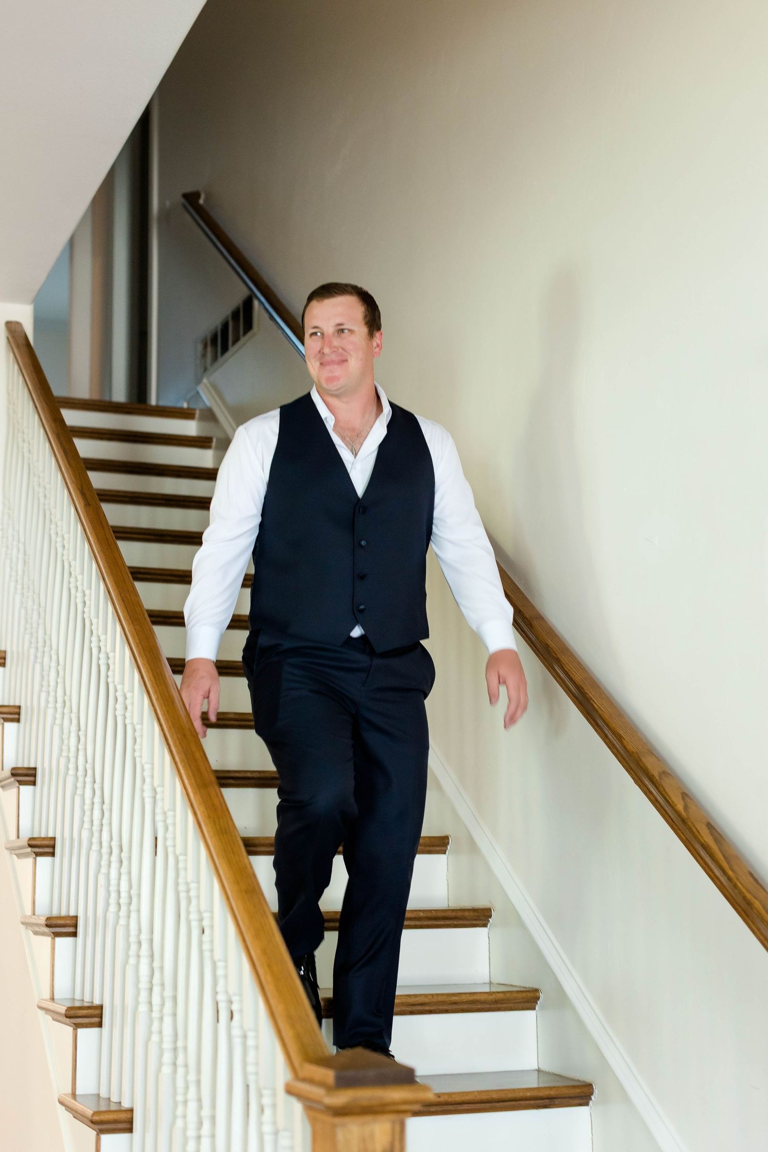 Person in formal attire descends wooden stairs in a sequence of candid shots.