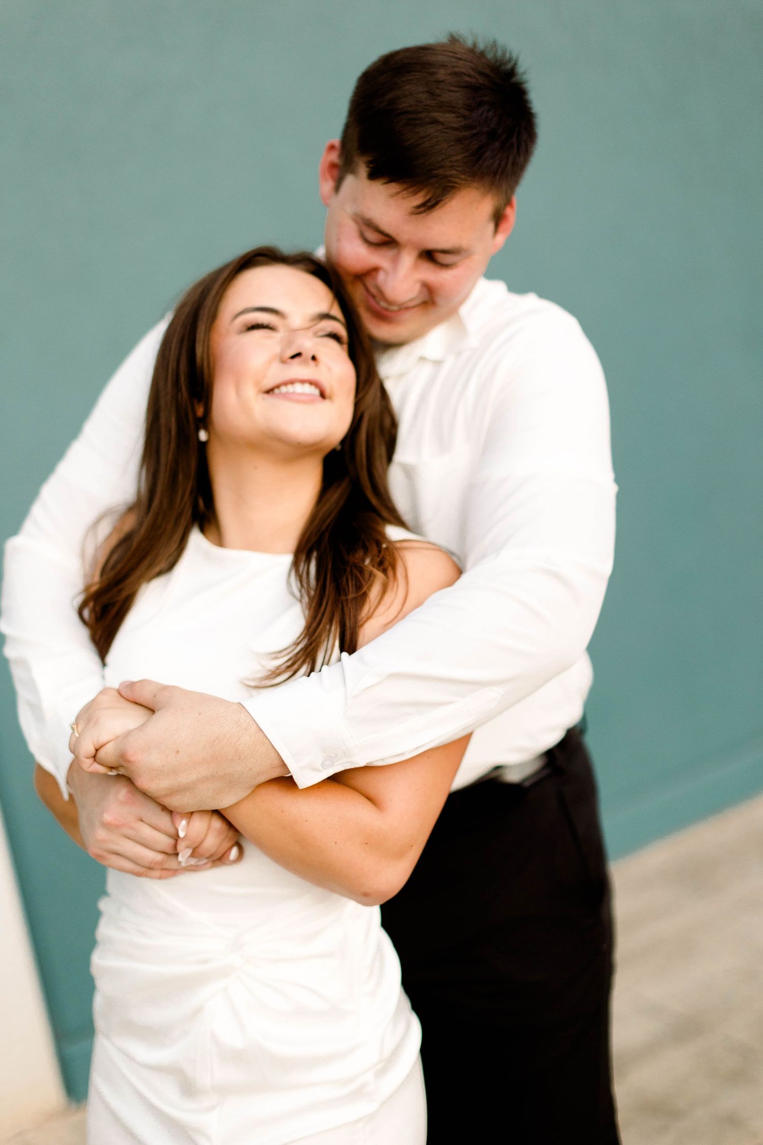 A series of candid moments showing a couple laughing and embracing during their engagement shoot.