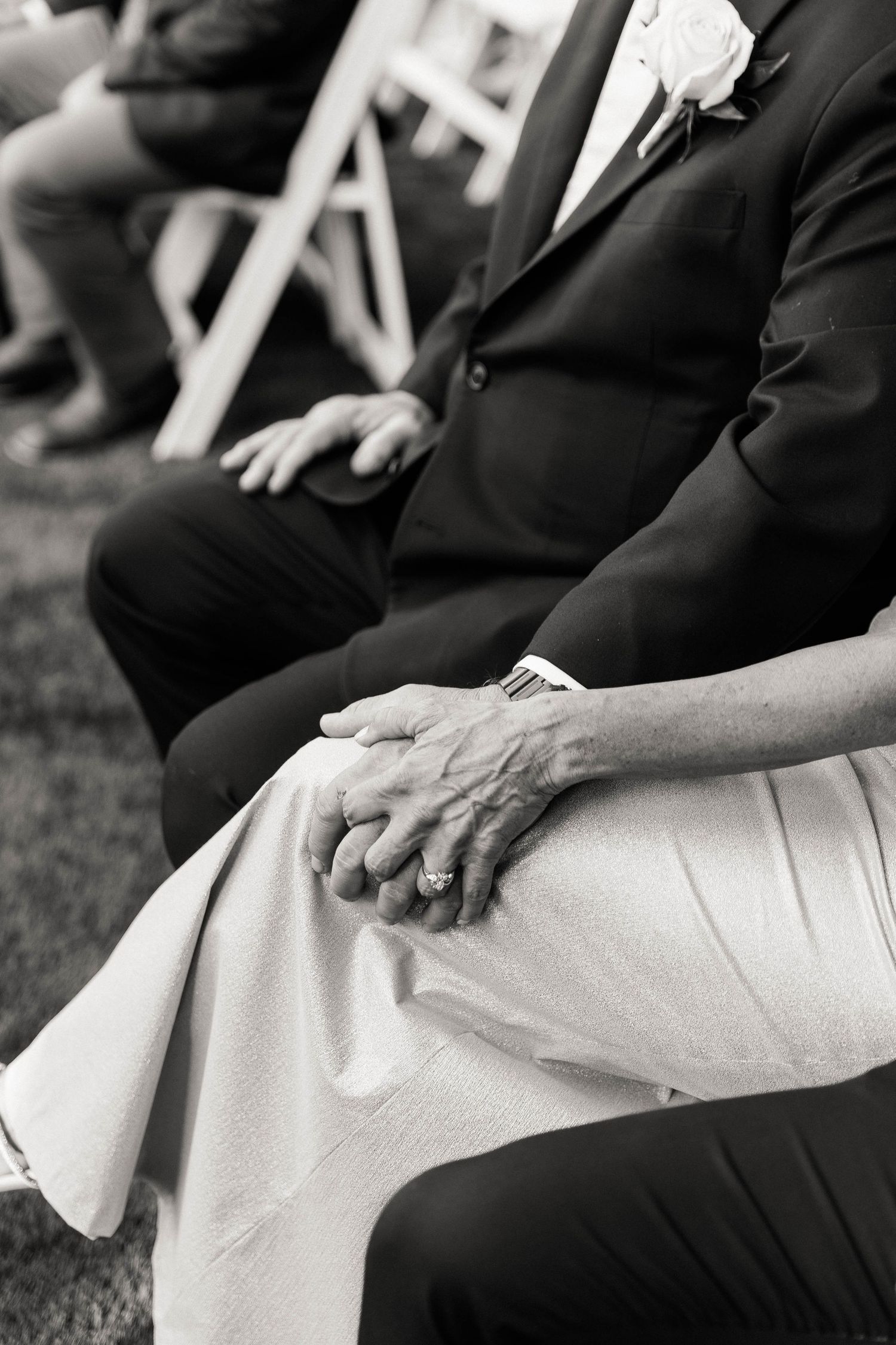 Close-up detail shot of formal wedding attire in black and white.