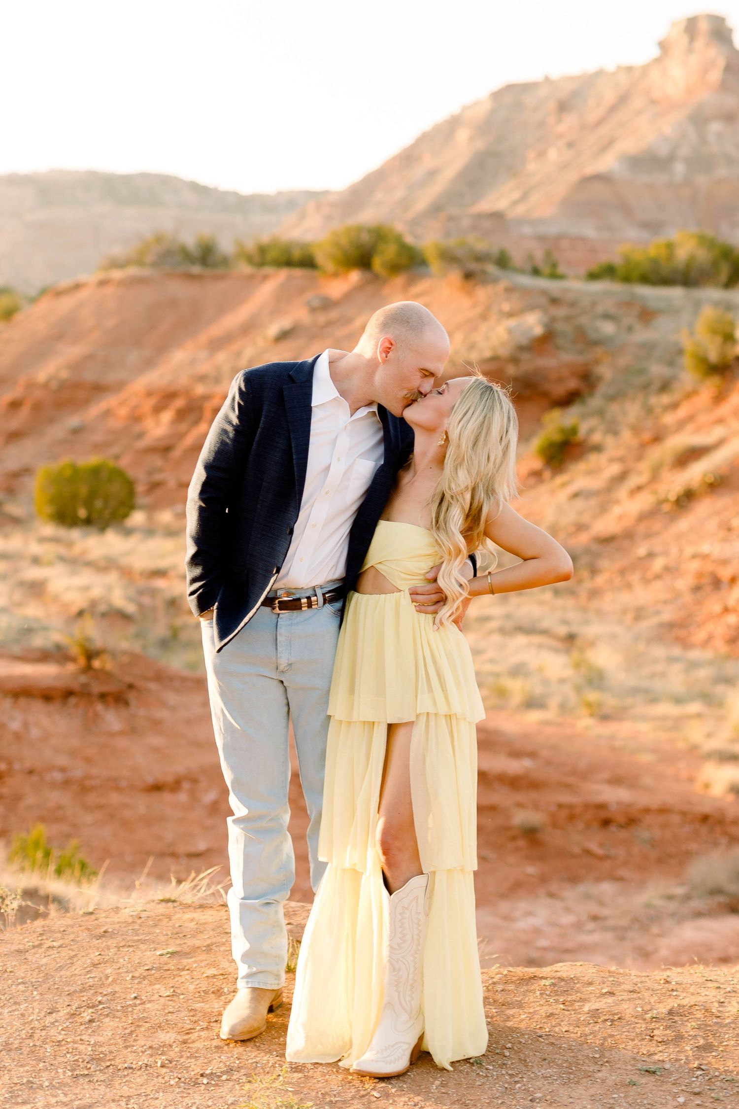 Intimate couple's portrait session in desert setting during golden hour.