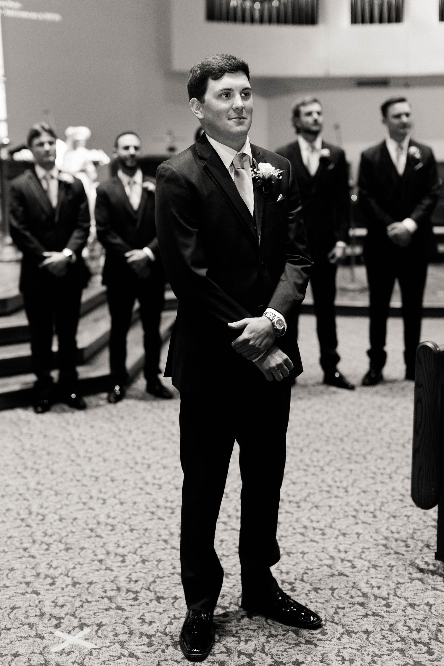 A formal wedding ceremony in progress inside a church with classic decor.