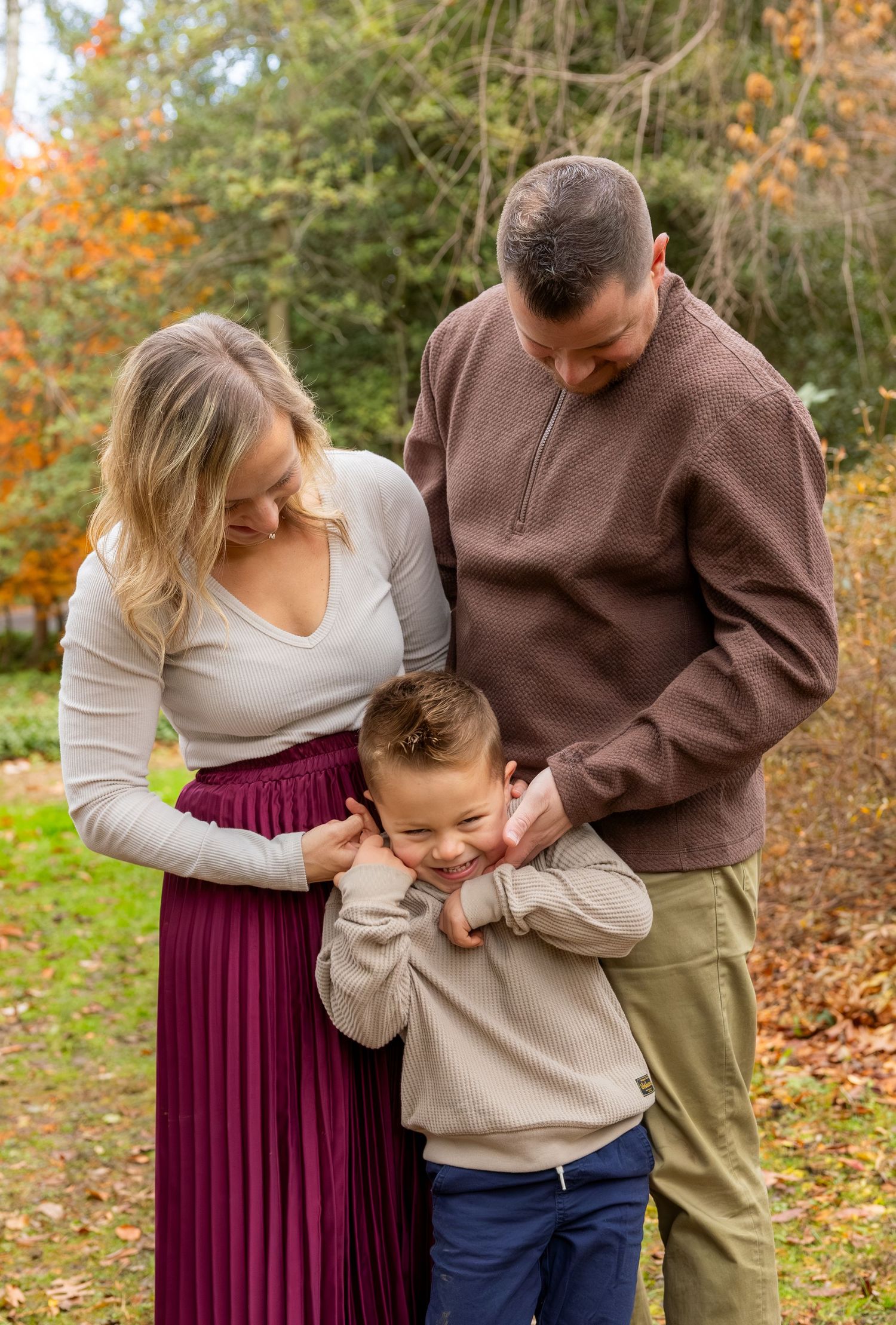A family shares tender moments together during a fall photoshoot in nature.
