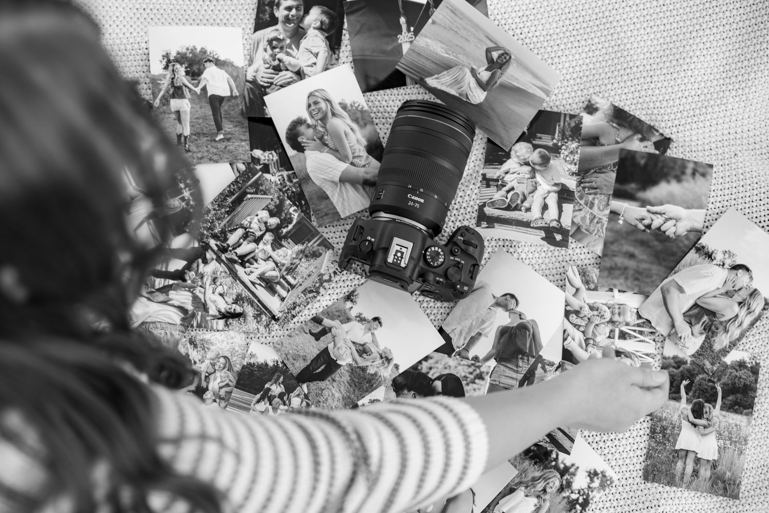 Vintage black and white photographs spread out in nostalgic display.
