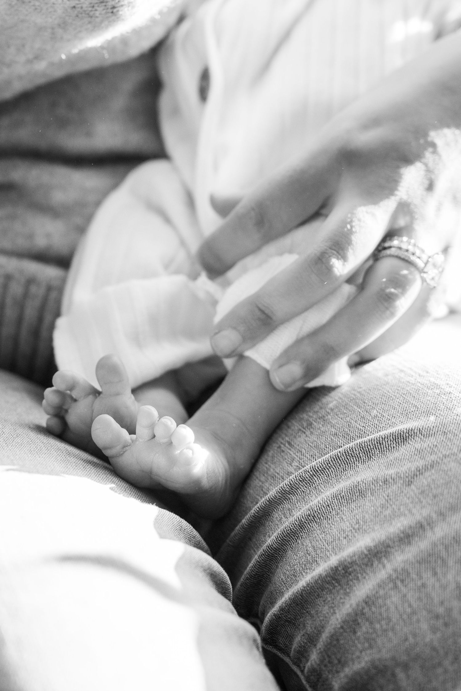 Black and white close-up of gentle hands touching.