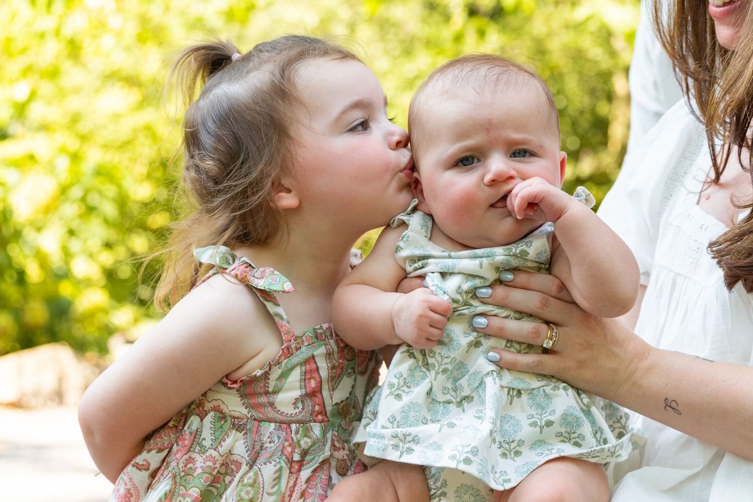 Candid family moments captured in a series of playful outdoor portraits.