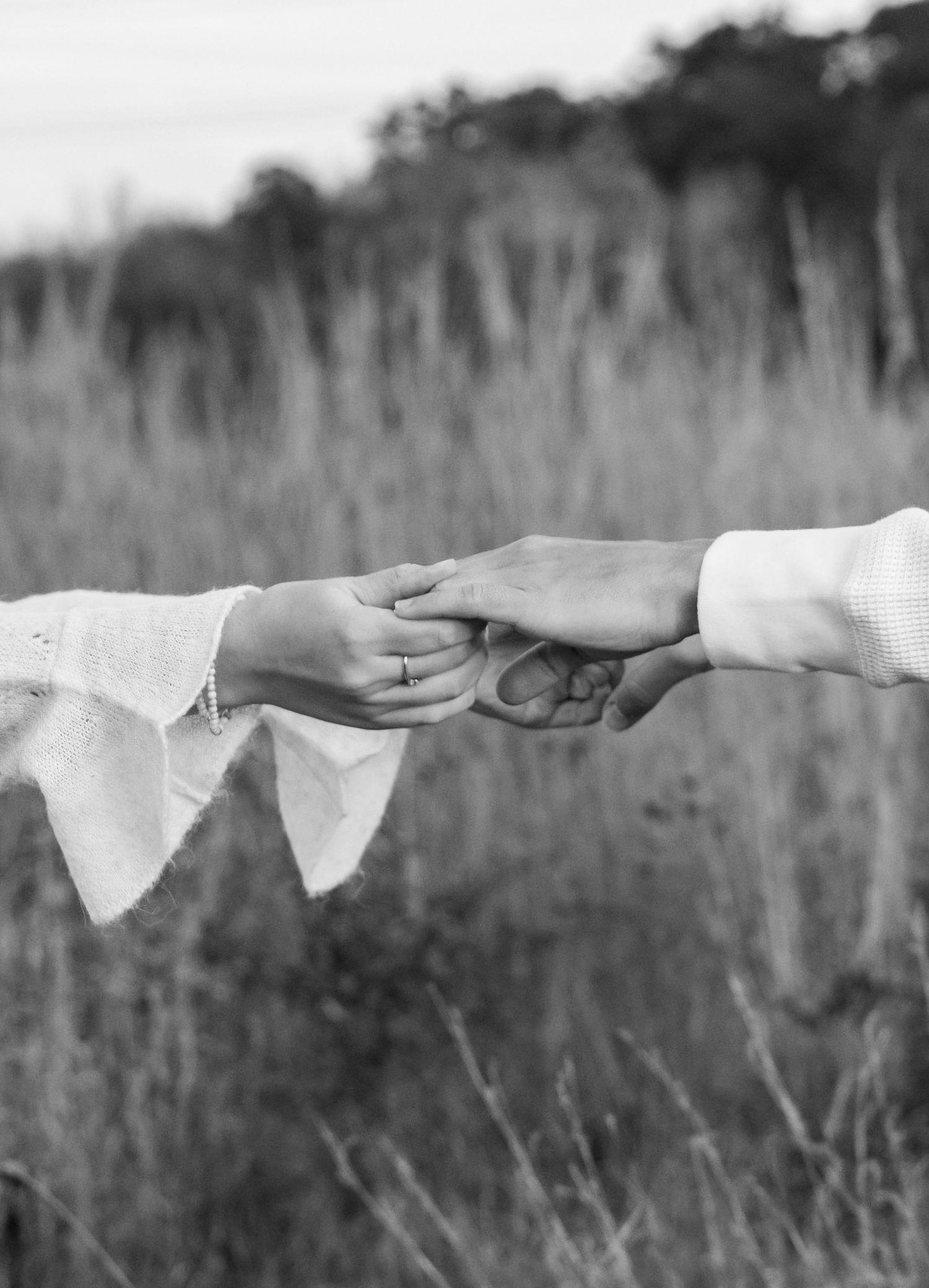 White lace fabric stretches horizontally across a blurred outdoor background.