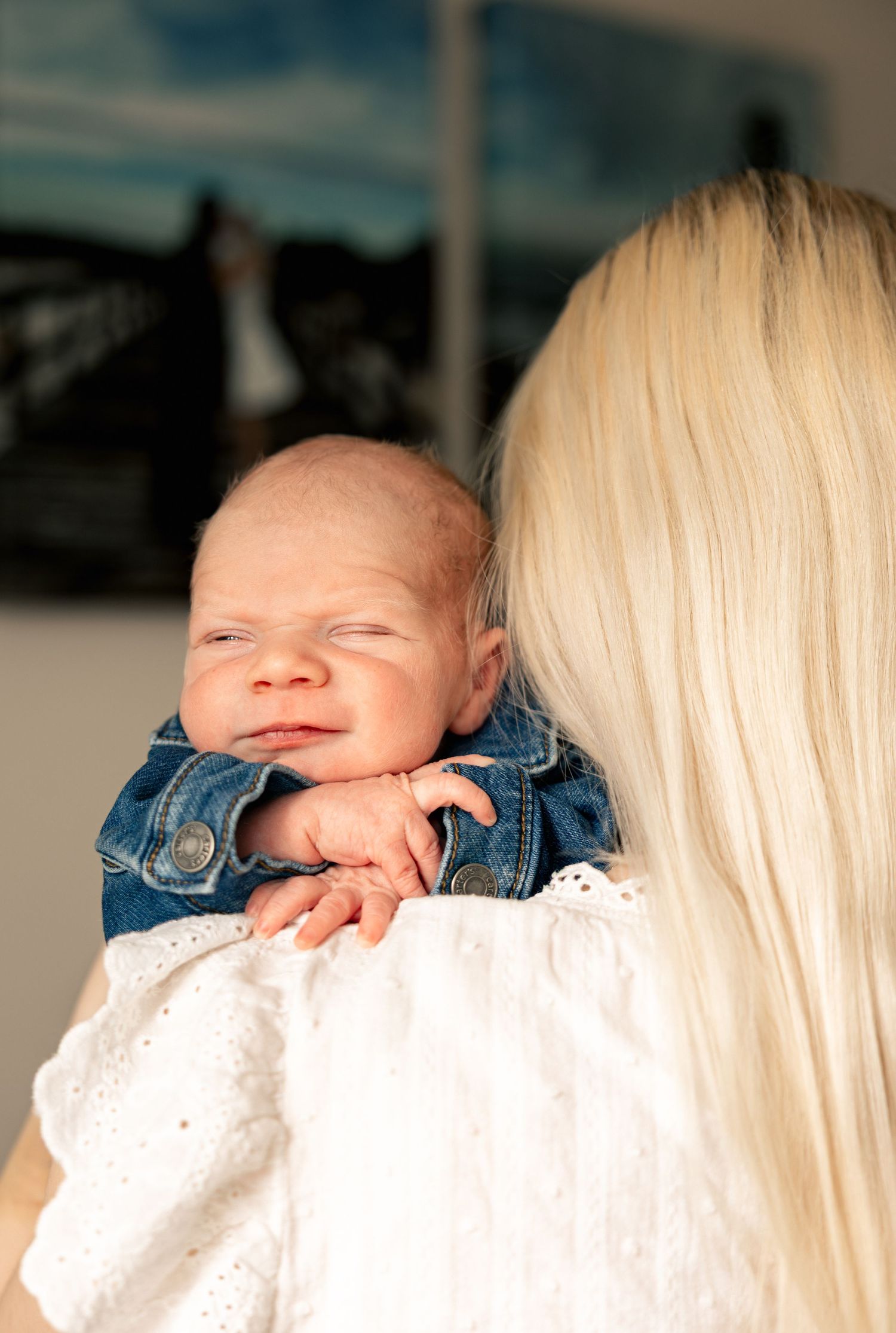 A series of tender moments showing a baby in a denim jacket being held against a white background.