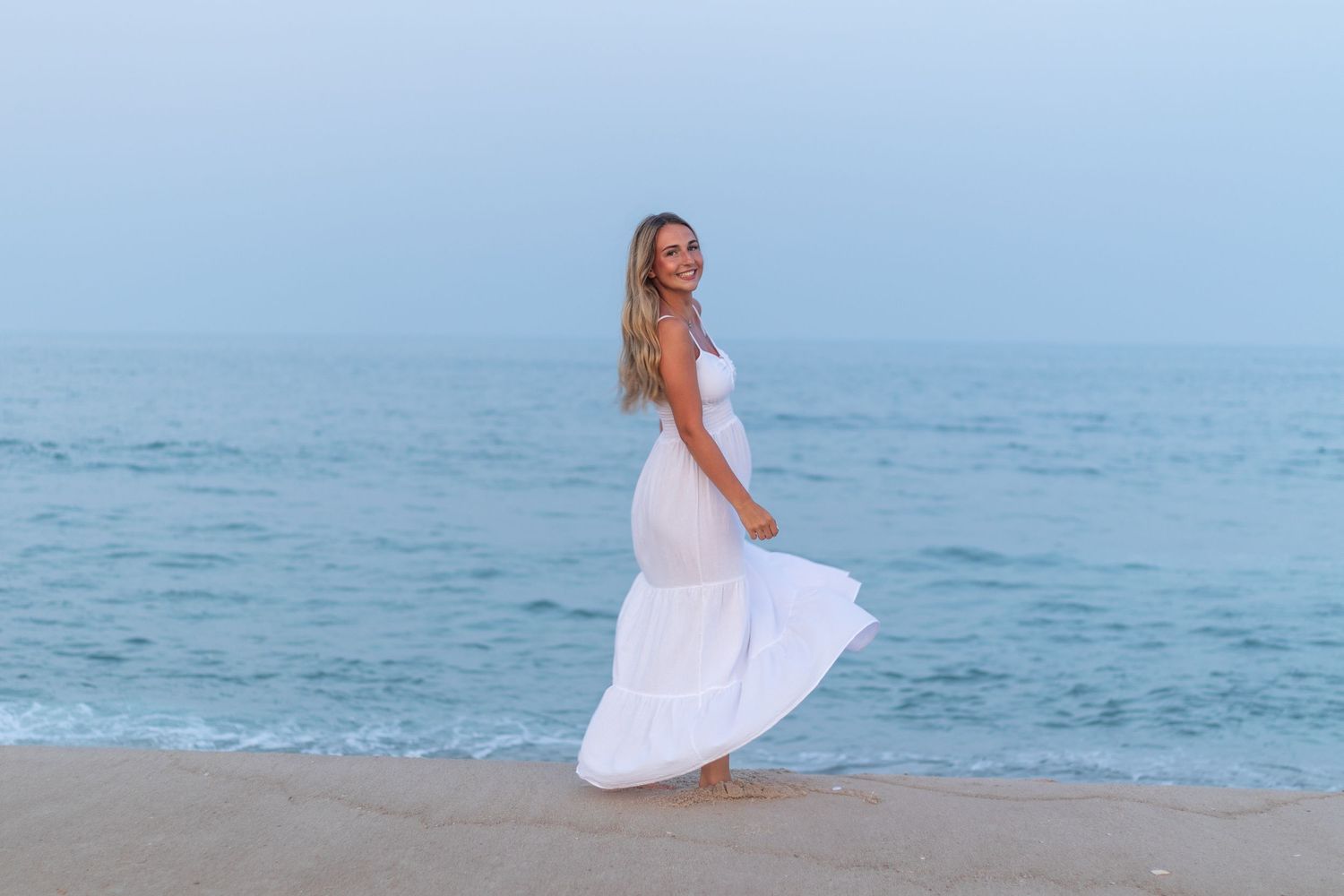 A sequence of beach portraits with white flowing dress against the ocean backdrop.