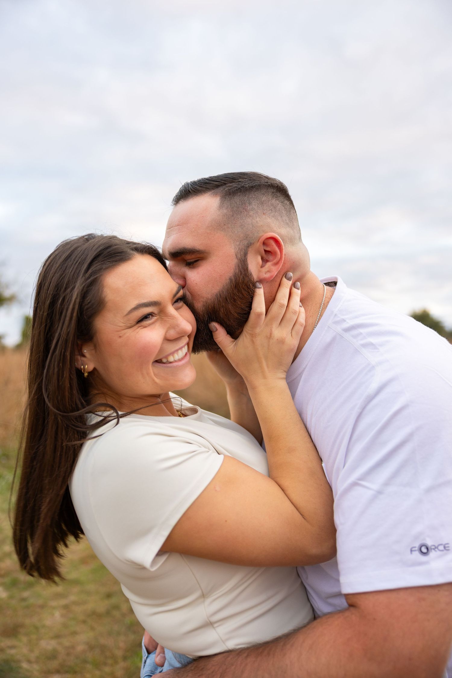 A romantic couple shares intimate moments and laughter in a series of candid outdoor photos.