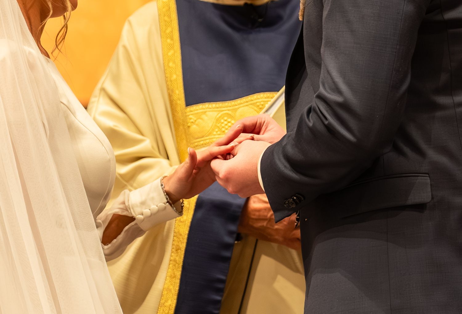 Close-up details of elegant white wedding dress and formal attire.
