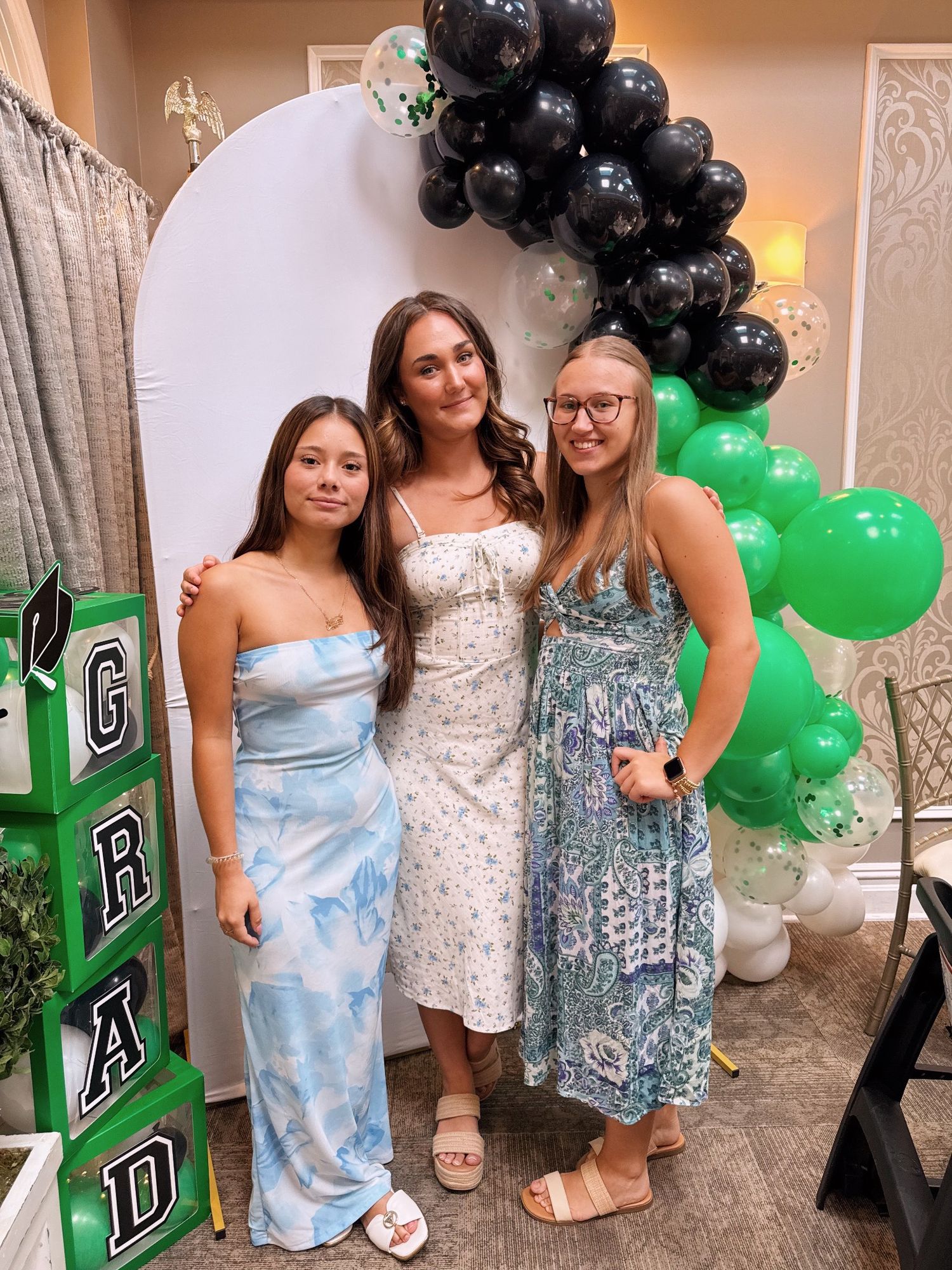 Party photos with black and green balloon decorations and people in formal dresses.