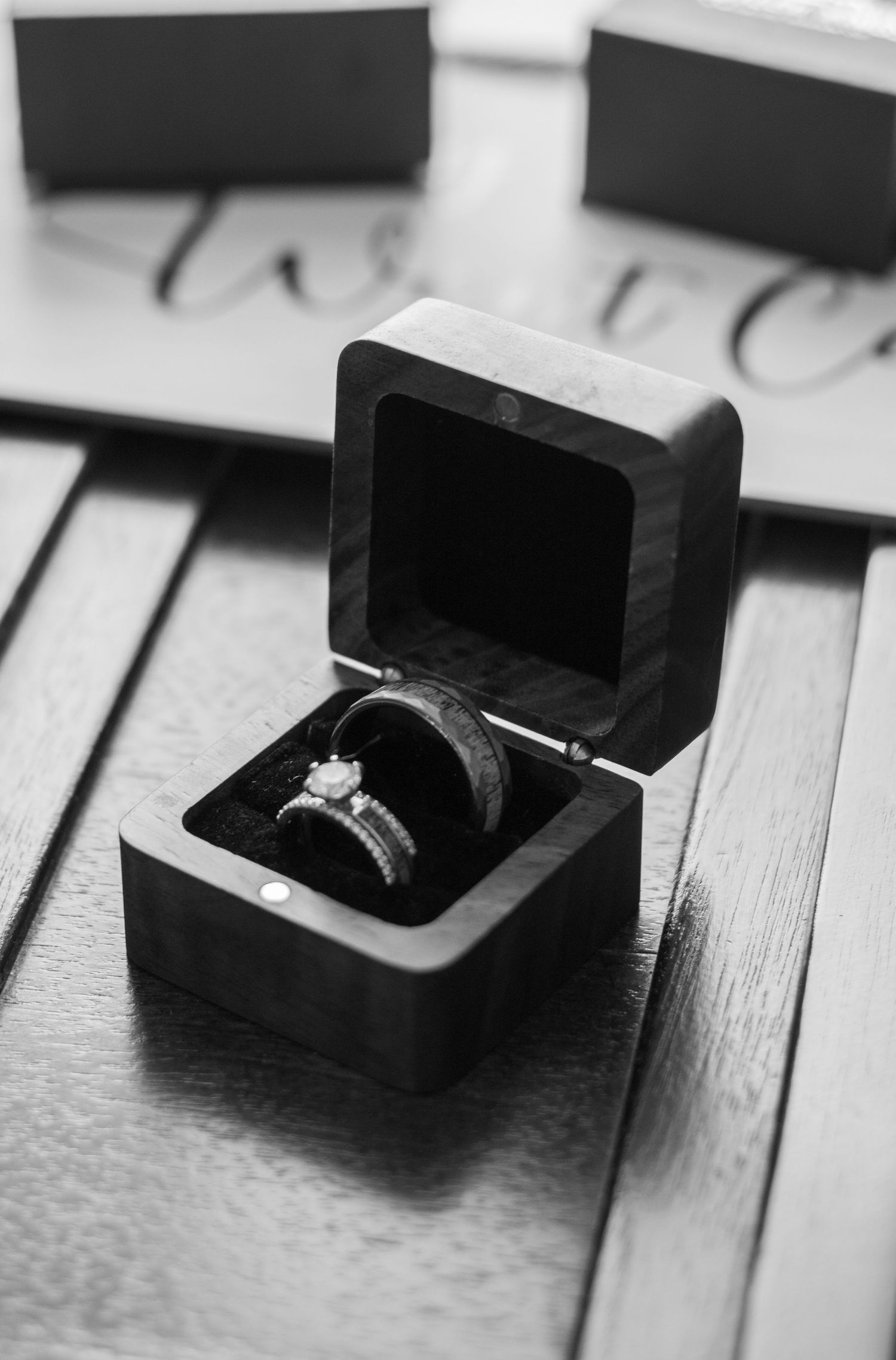 Diamond engagement ring in black box photographed in dramatic black and white.