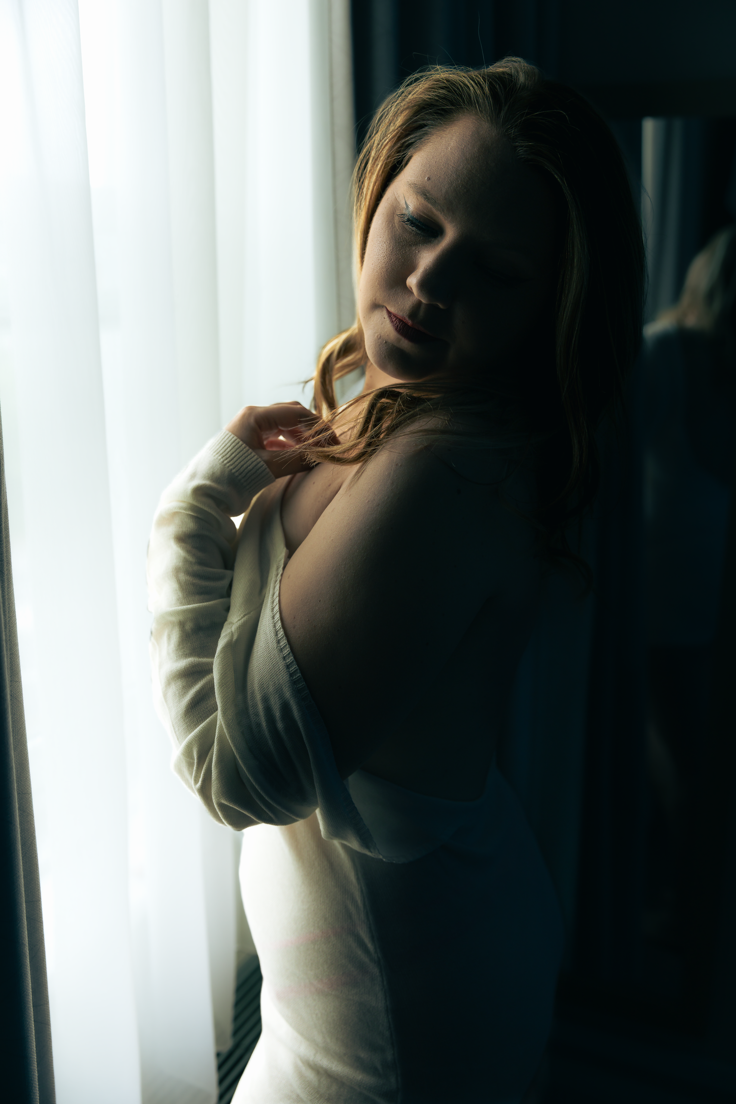 Soft backlit portrait series against white curtains creating ethereal atmosphere.