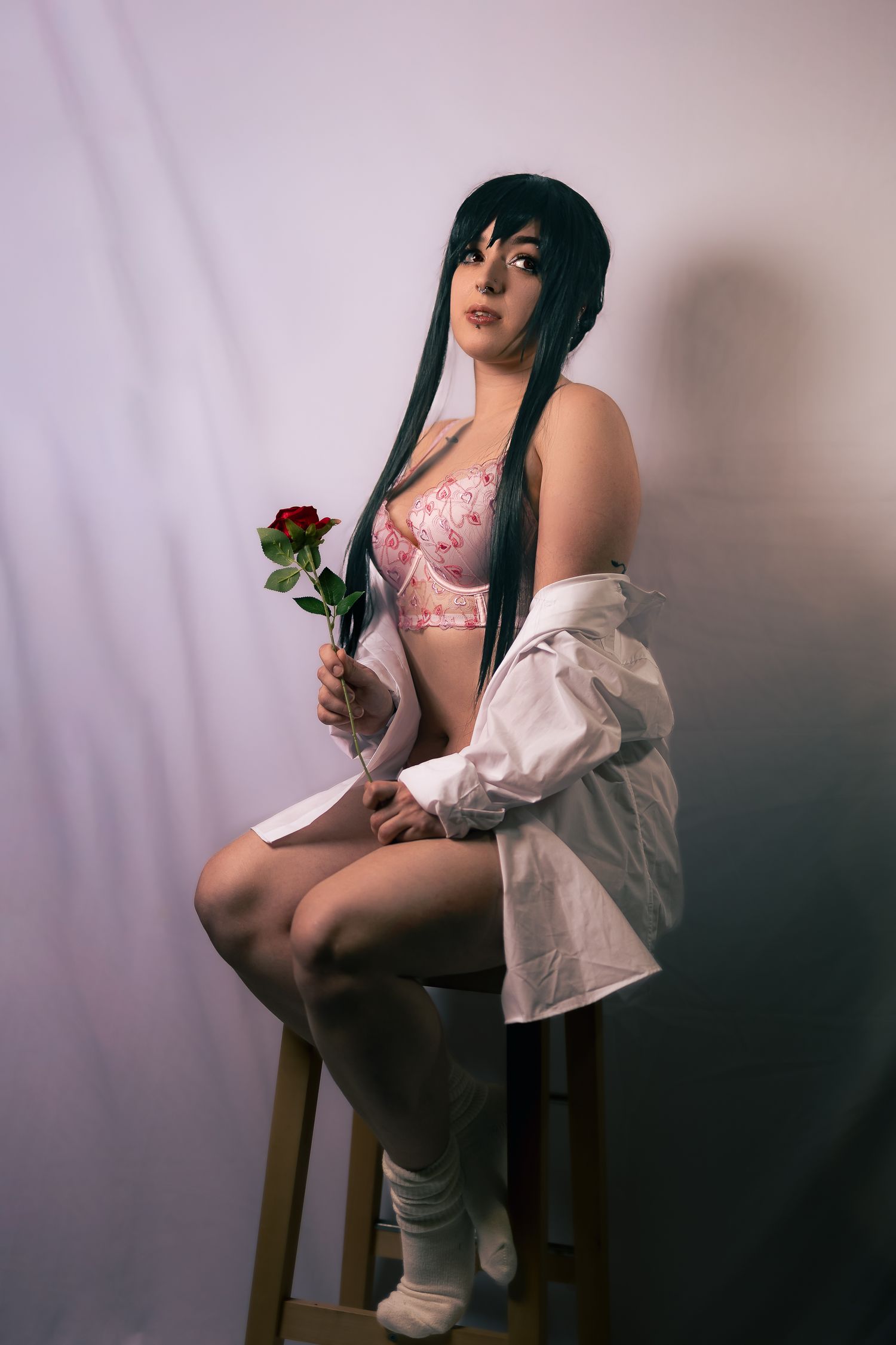 Artistic boudoir photoshoot featuring pink lingerie and white button-up shirt with a single rose.