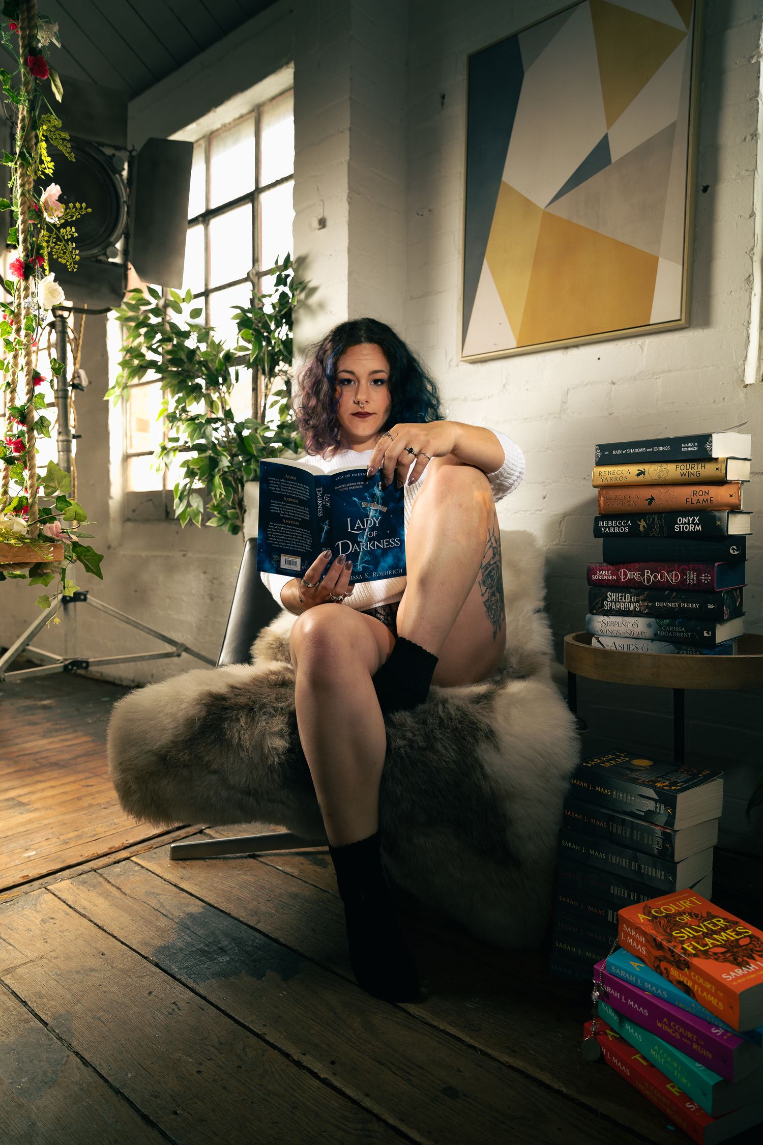 Artistic portrait series in rustic loft setting with books and geometric wall art.