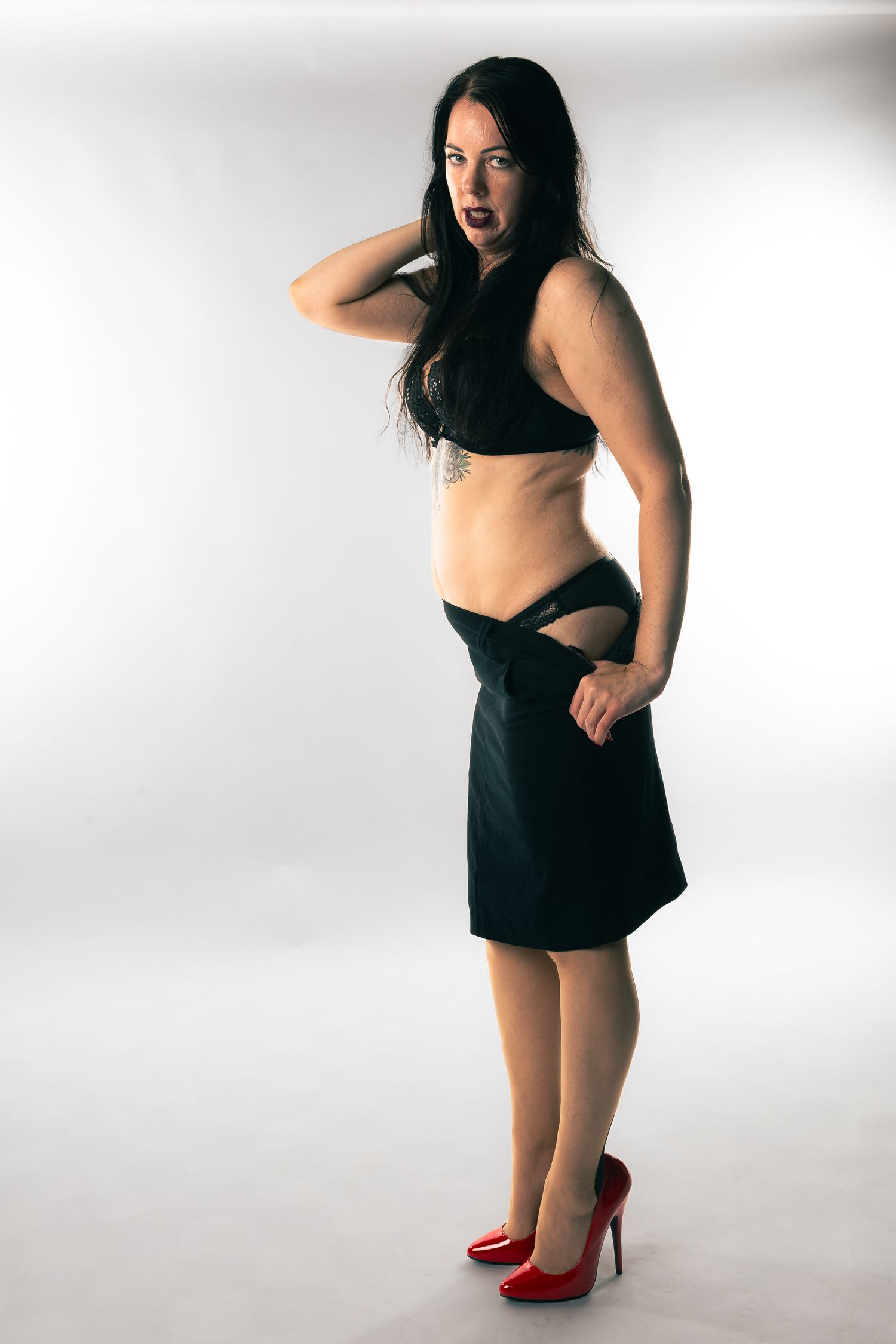 Fashion photo sequence with model in black outfit and red heels against white background.