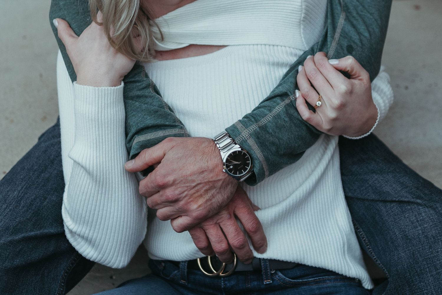 Cozy winter engagement session in Lapeer, Michigan with a couple standing together on a porch in soft natural light
