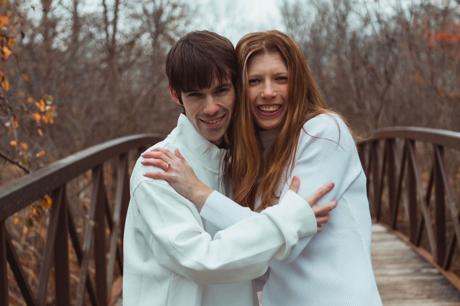 Romantic fall engagement session in Oakland County with a couple surrounded by autumn foliage