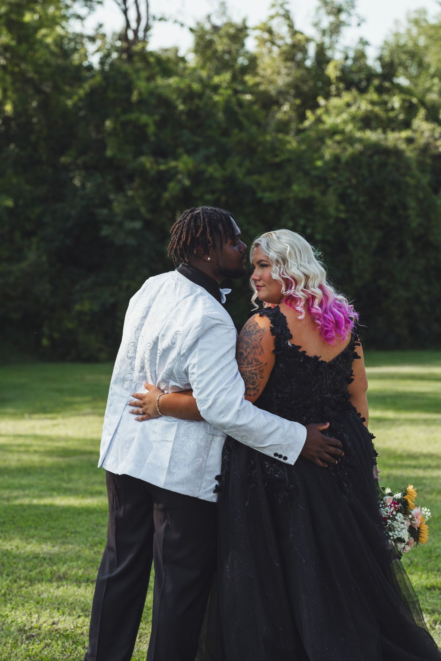 Intimate Flint Michigan wedding couple portrait captured outdoors with the couple embracing in natural light