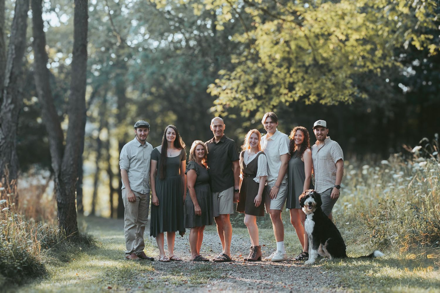Outdoor family photography session in Oakland County, Michigan featuring a multi-generation family on a wooded trail in natural light