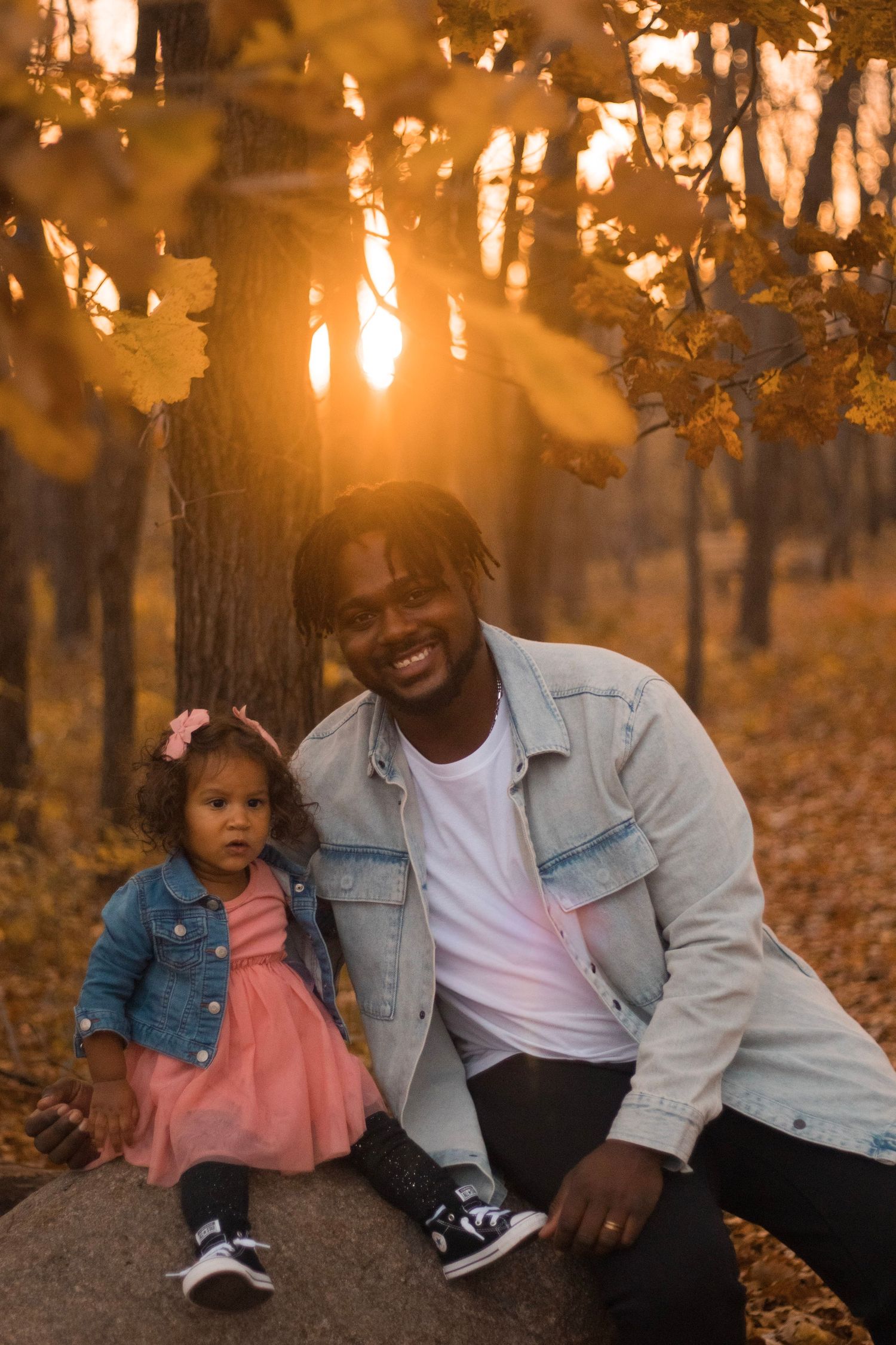 Fall family photo session in Genesee County, Michigan featuring a family together surrounded by autumn foliage