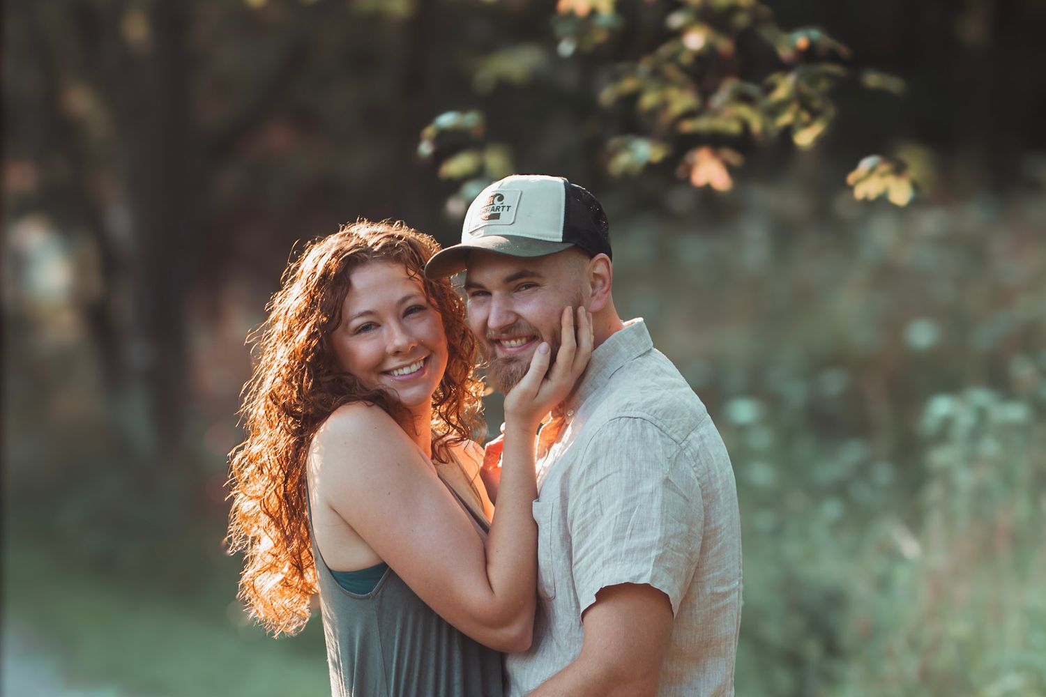 Outdoor couples portrait during an Oakland County family photo session featuring a couple standing together on a wooded trail