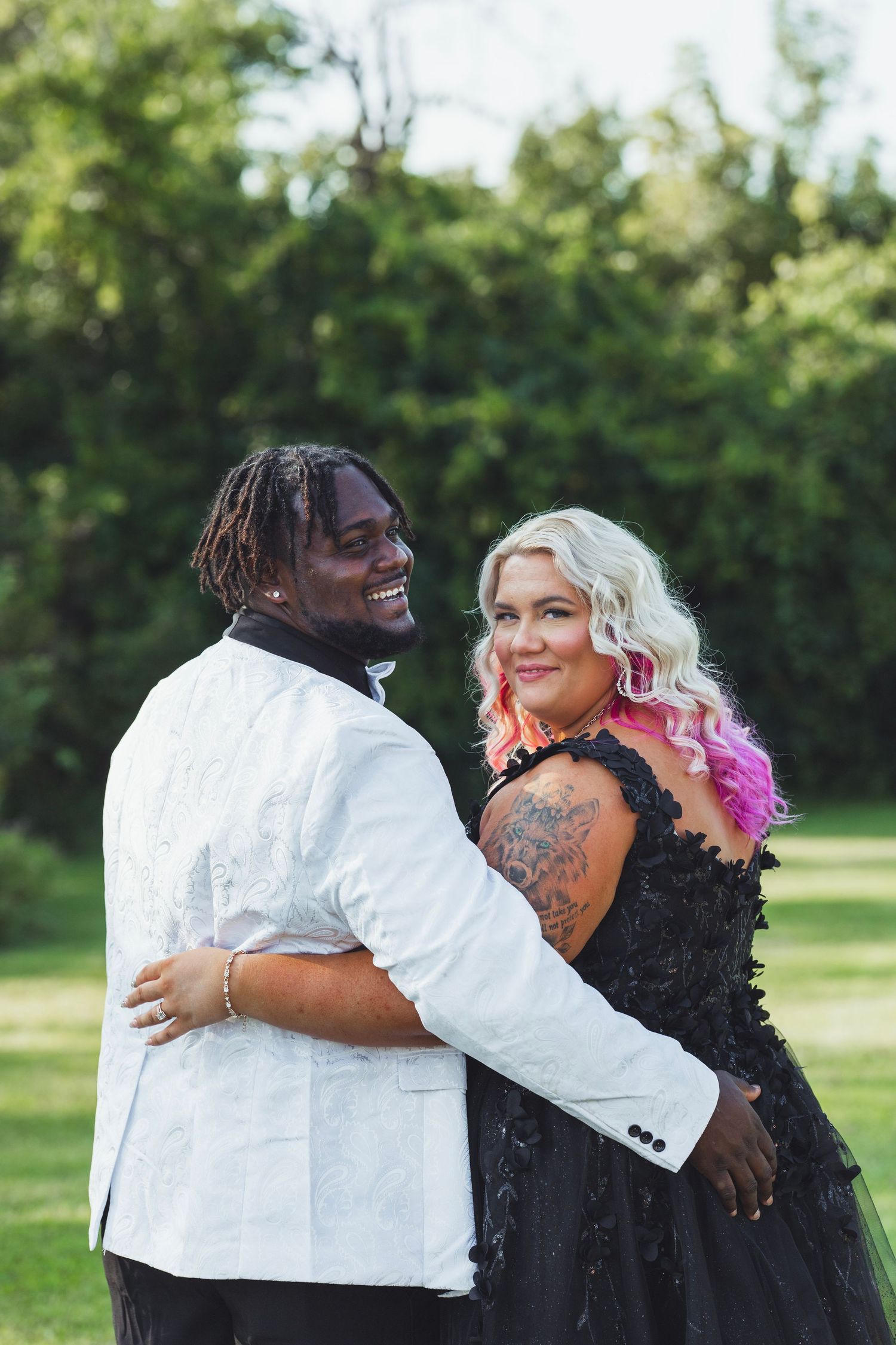 Intimate Flint Michigan wedding couple portrait captured outdoors with the couple embracing in natural light