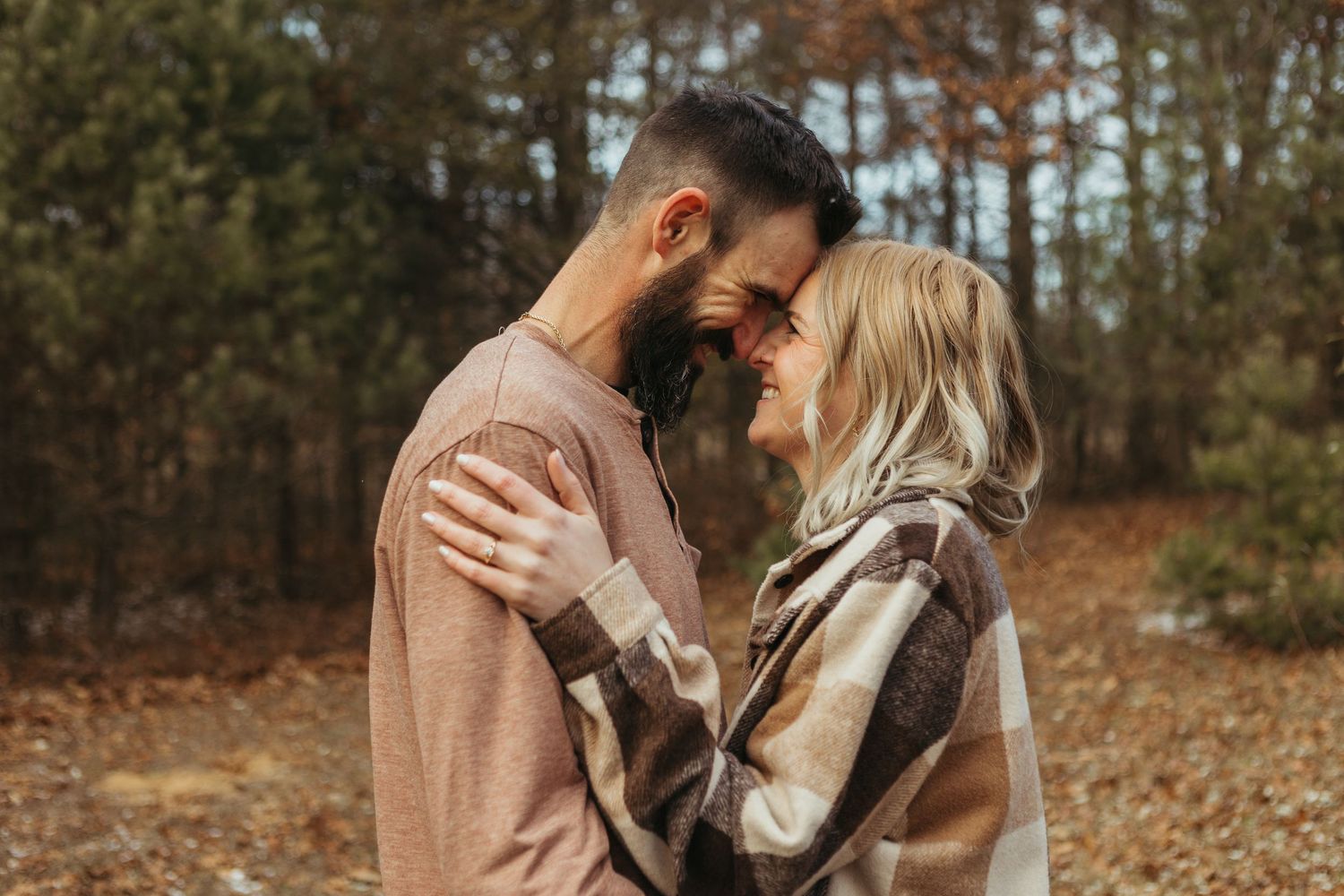Winter engagement photo session in Lapeer, Michigan featuring a couple outdoors in a snowy natural setting