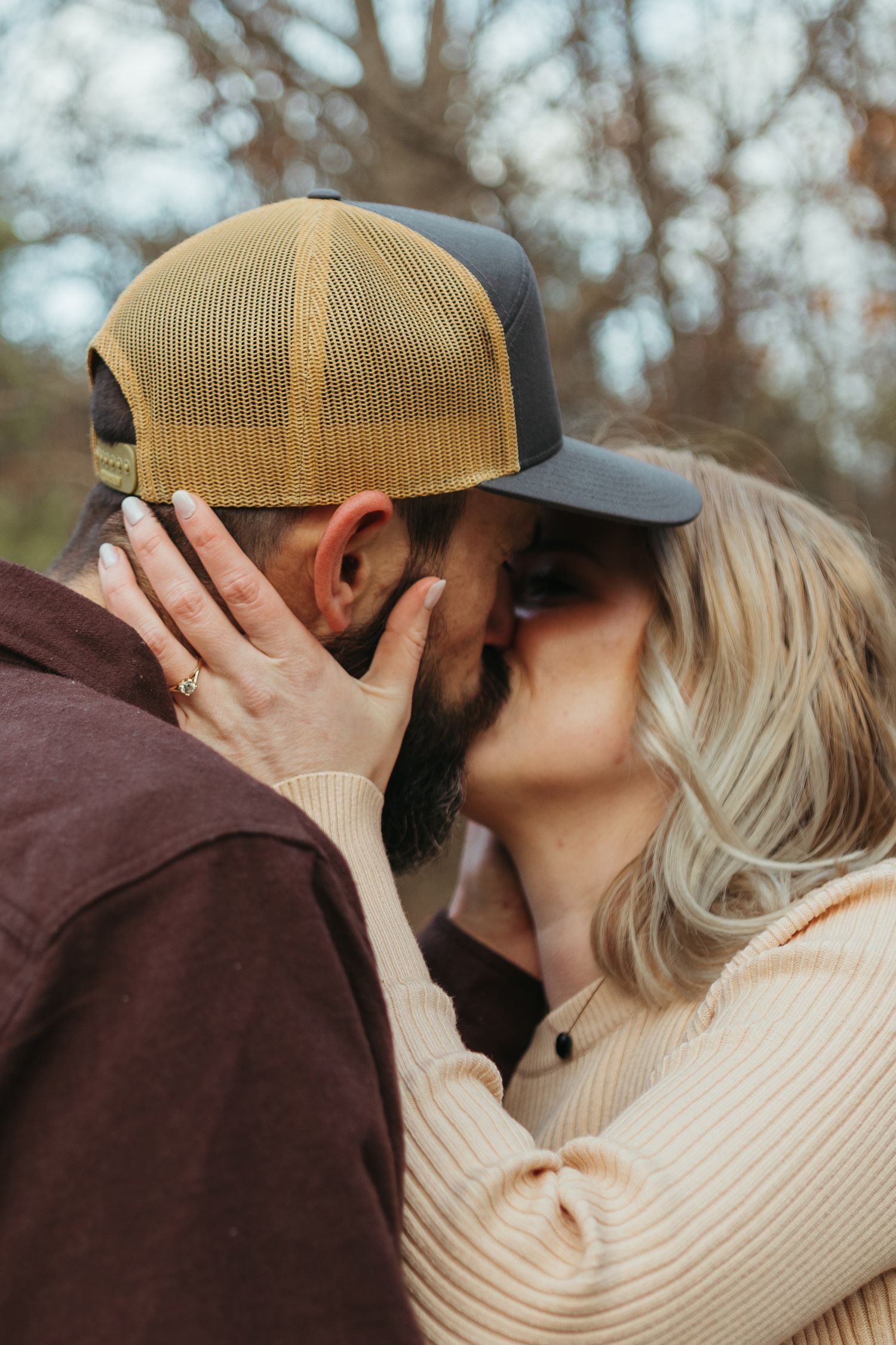 Winter engagement photo session in Lapeer, Michigan featuring a couple outdoors in a snowy natural setting