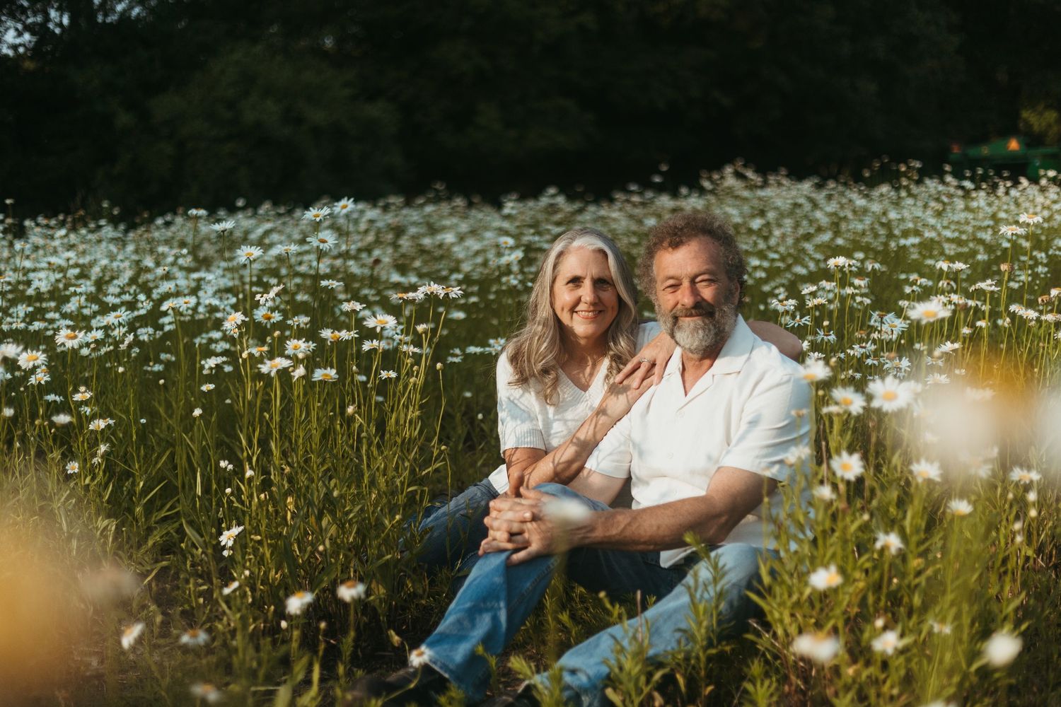 Couple embracing in a wildflower field during a family session with a Southeast Michigan photographer near Detroit.