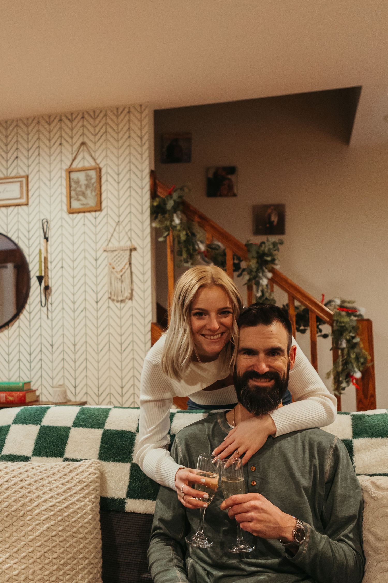 In-home winter engagement photos in Lapeer, Michigan capturing a couple together in a warm and intimate setting