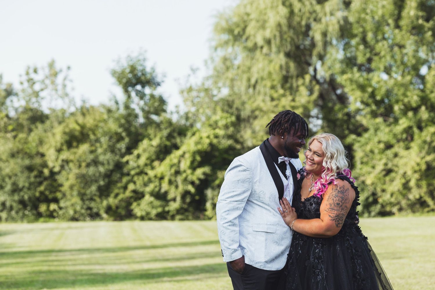 Emotional wedding portrait in Flint, Michigan featuring a couple sharing a quiet moment outdoors on their wedding day