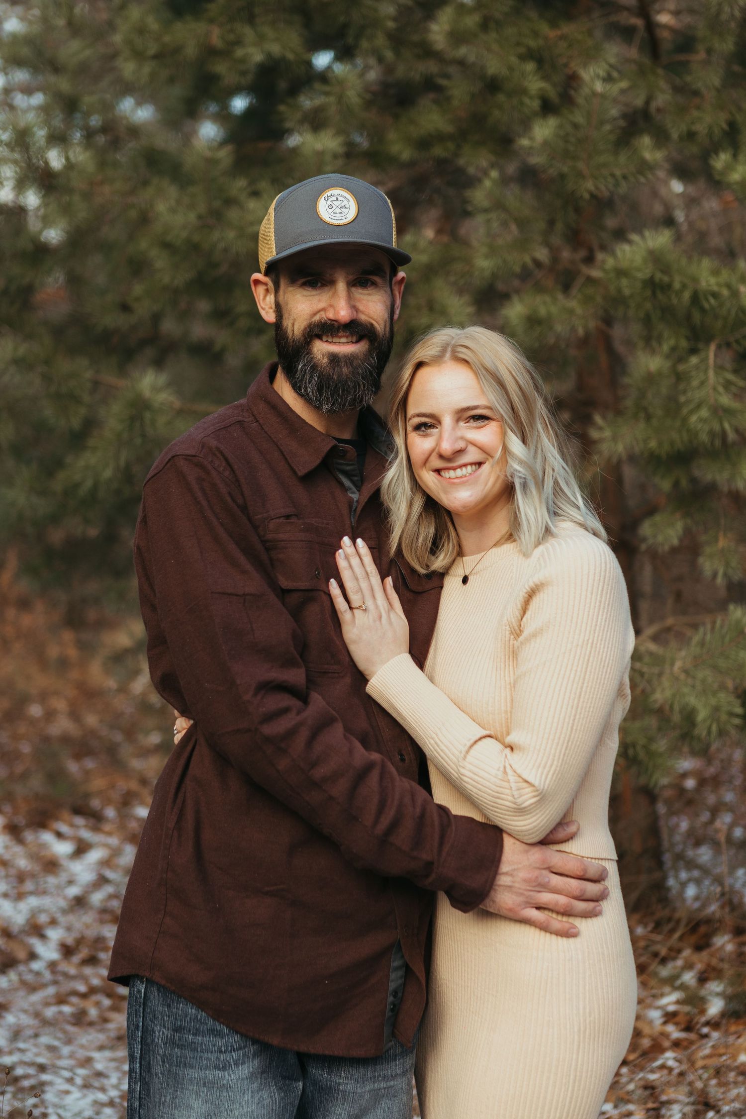 Winter engagement photo session in Lapeer, Michigan featuring a couple outdoors in a snowy natural setting