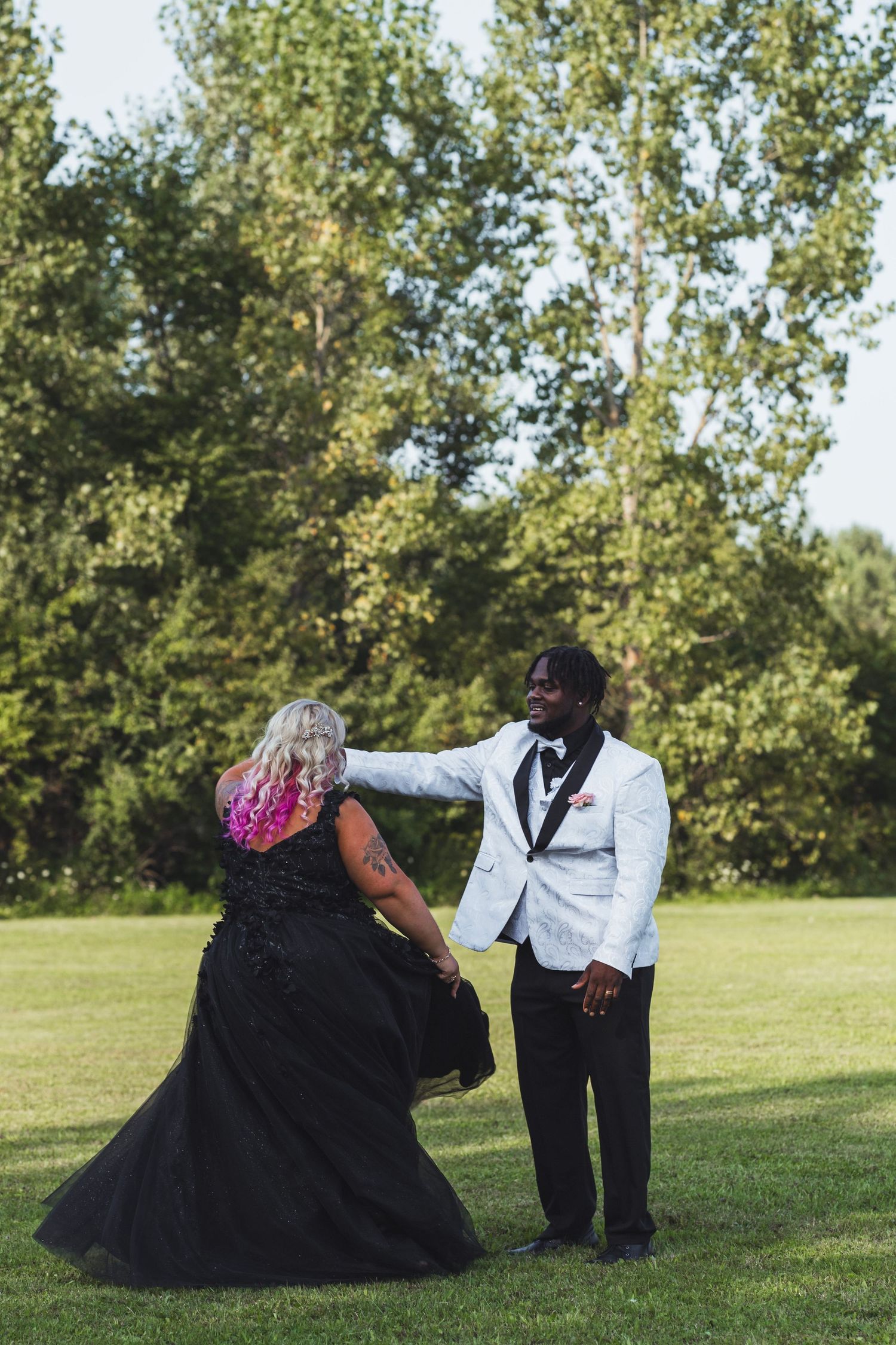 Romantic outdoor wedding portrait from a Flint, Michigan wedding with the couple standing together in a scenic setting